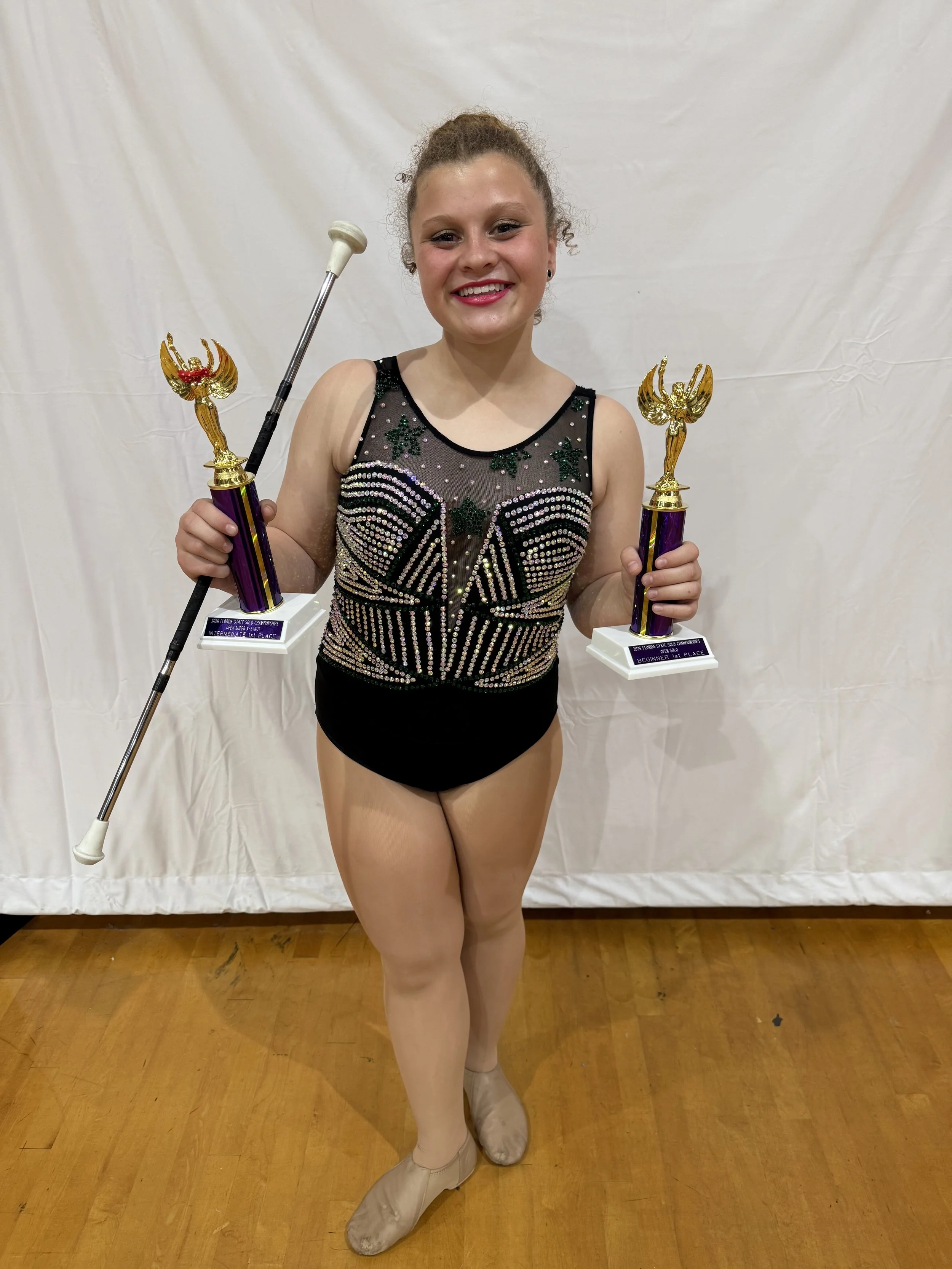 FLARE Baton Team Competitive Twirler posing with her hard earned competition awards from the 2026 Florida State Twirling Championship!