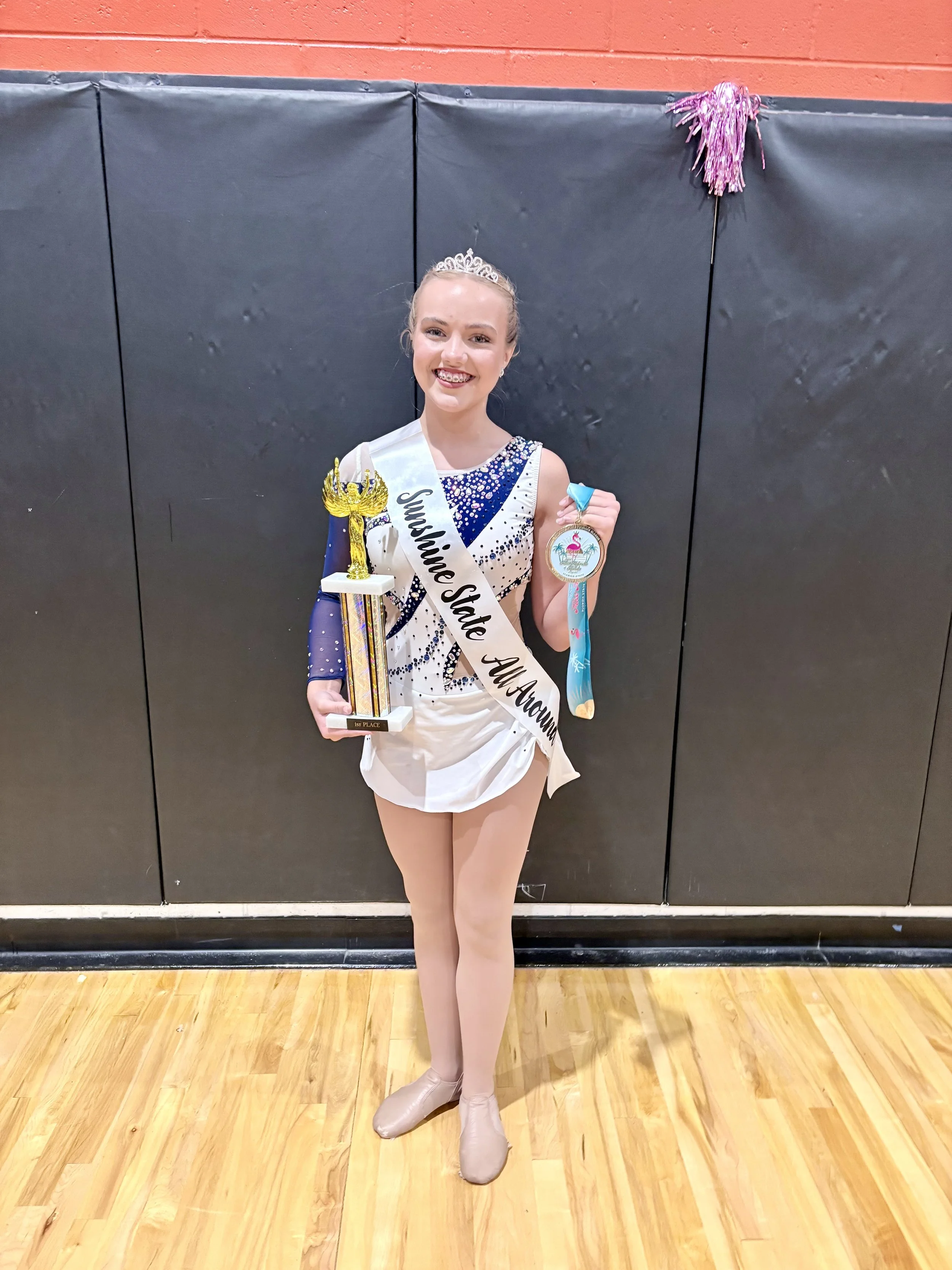 FLARE Baton Team Competitive Twirler posing with her hard earned competition awards from the 2026 Miss Majorette of Florida Competition!