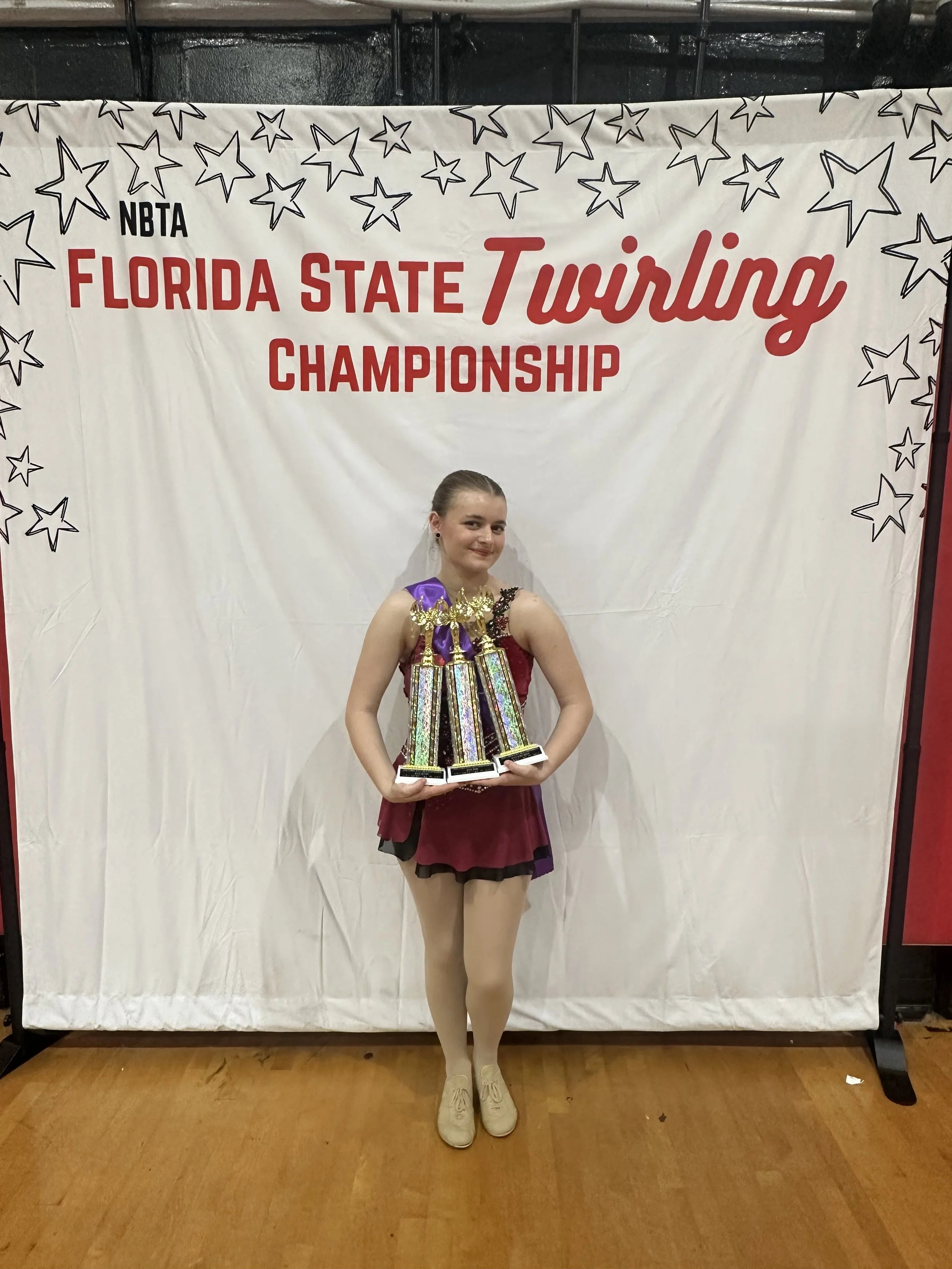 FLARE Baton Team Competitive Twirler posing with her hard earned competition awards from the 2026 Florida State Twirling Championship !