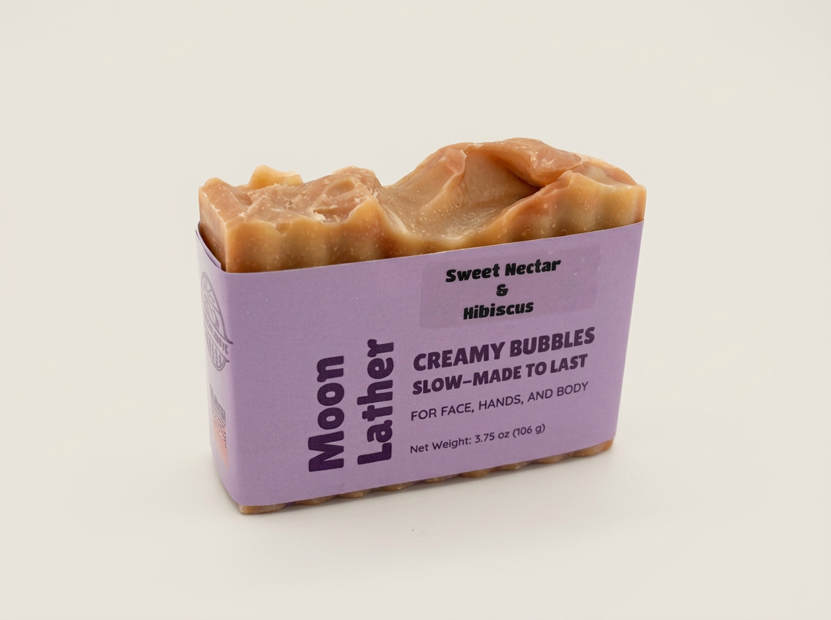 Sweet Nectar and Hibiscus Moon Lather soap with a warm orange swirled top