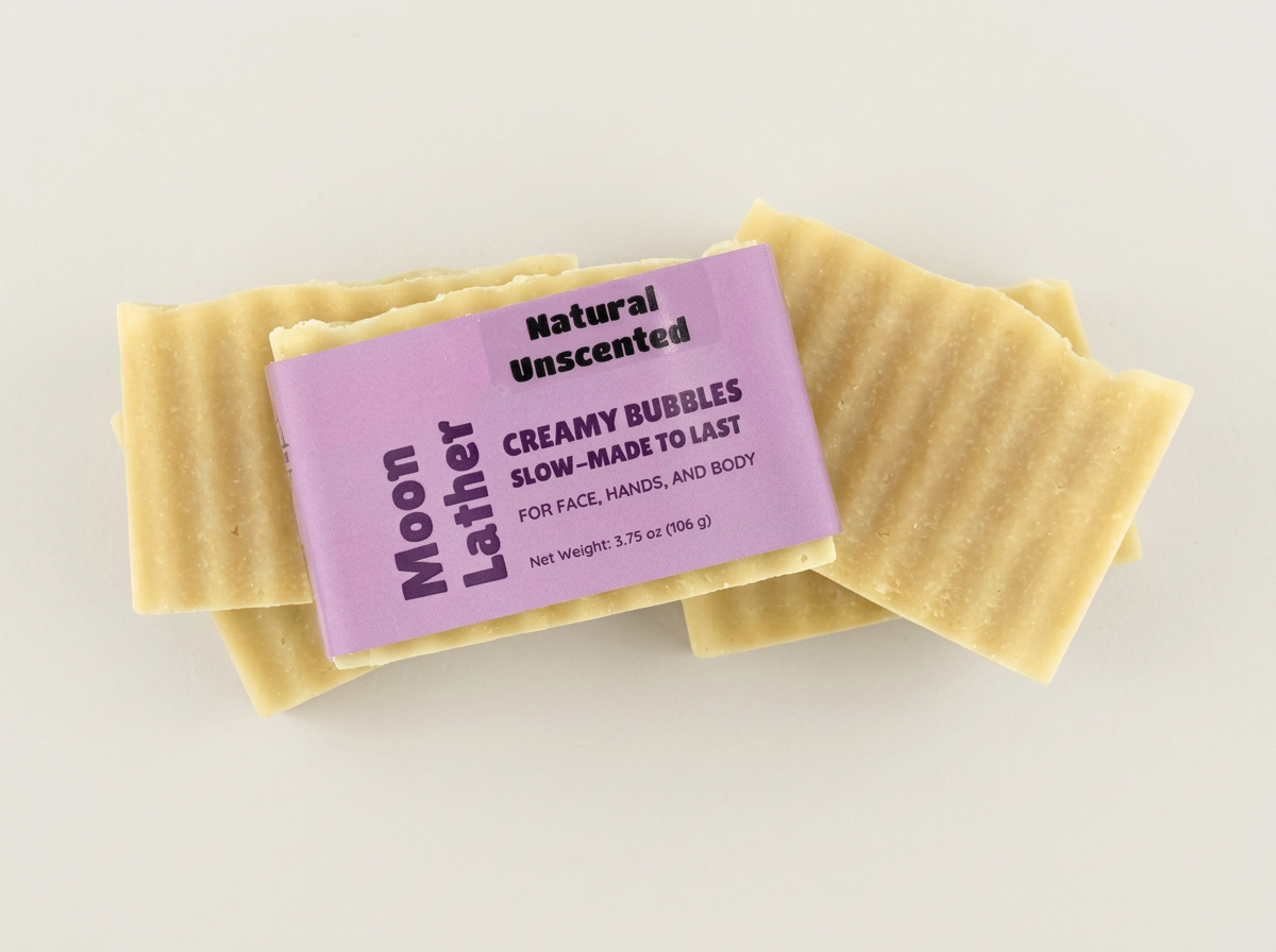 Natural Unscented Moon Lather soap displayed with two unwrapped bars