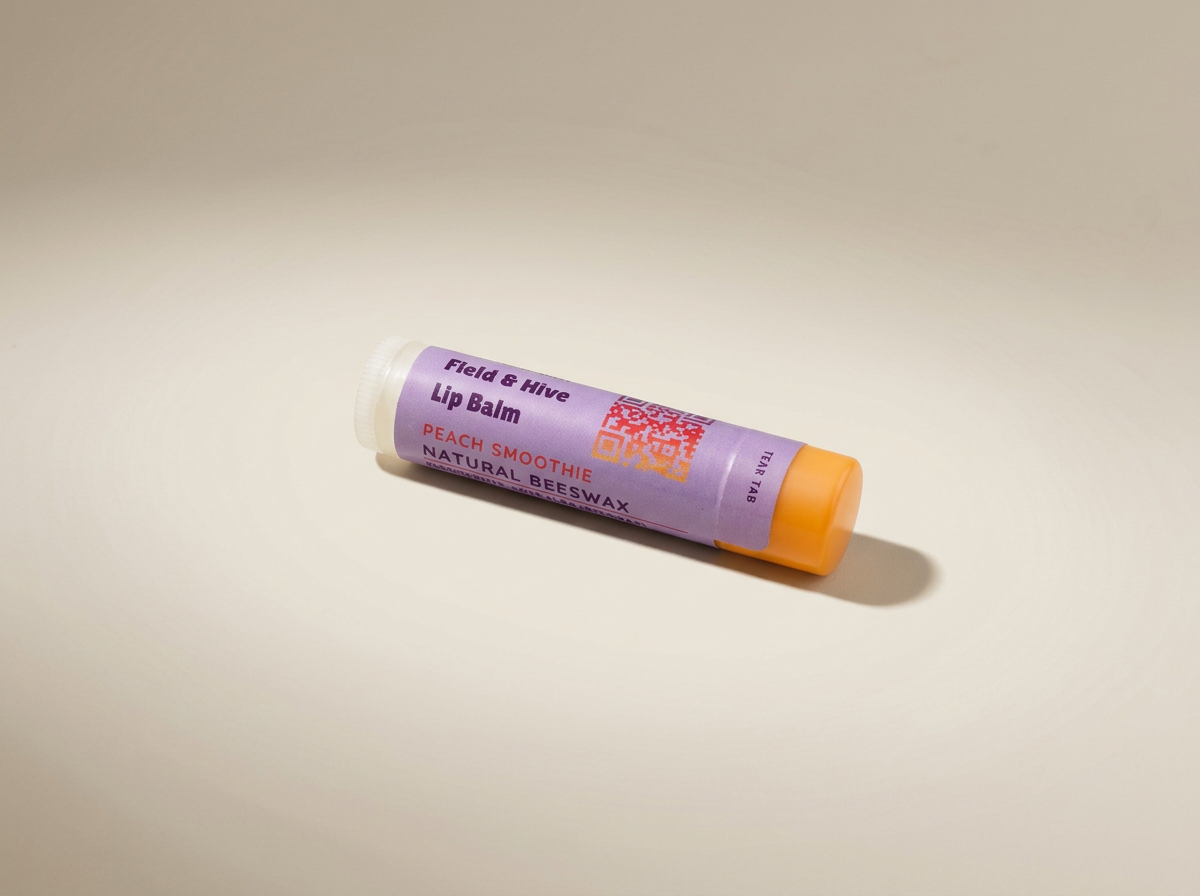 Field & Hive beeswax Peach Smoothie lip balm tube with an orange cap