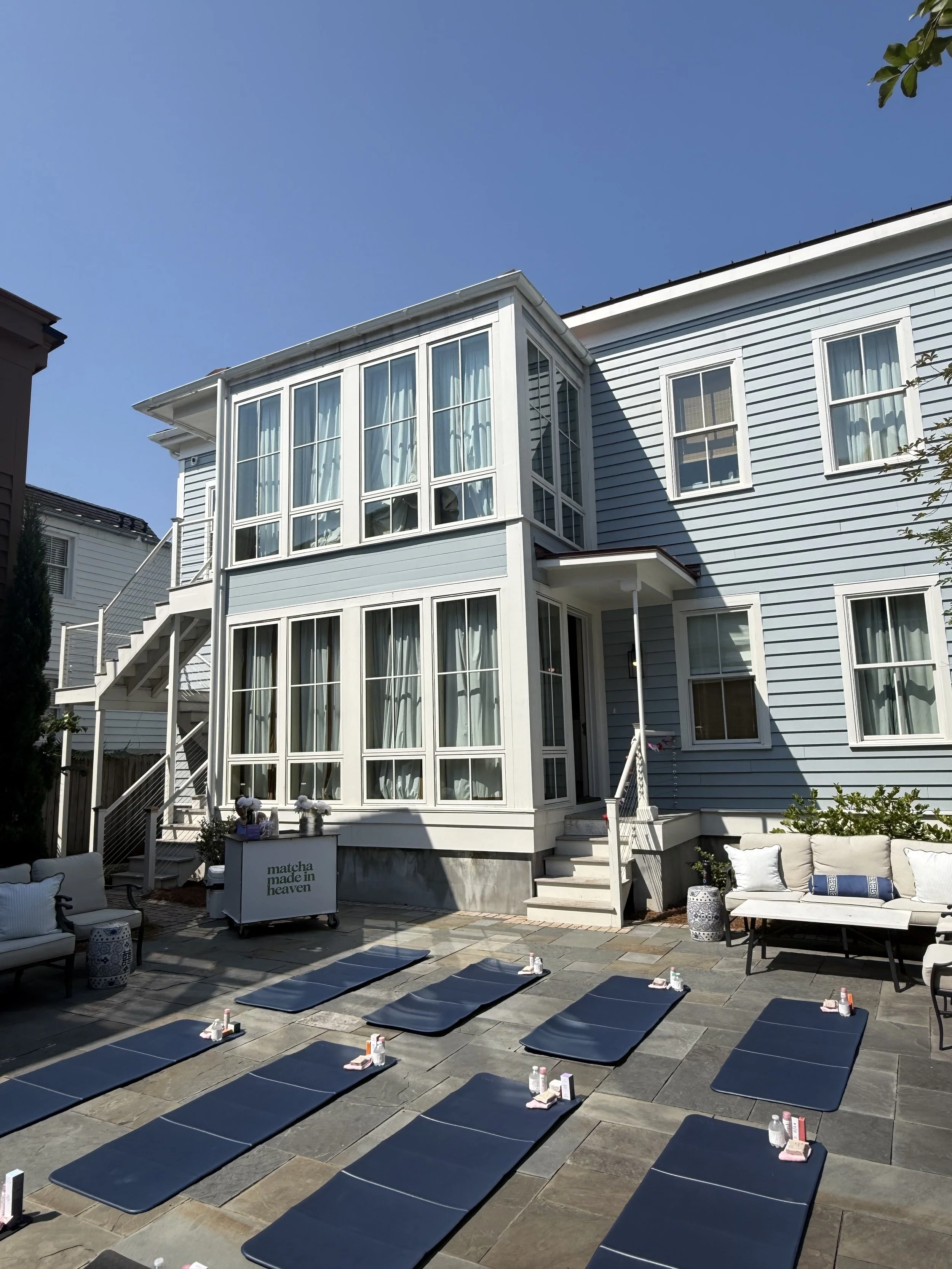 Eight blue pilates mats set up for a Charleston bachelorette pilates class