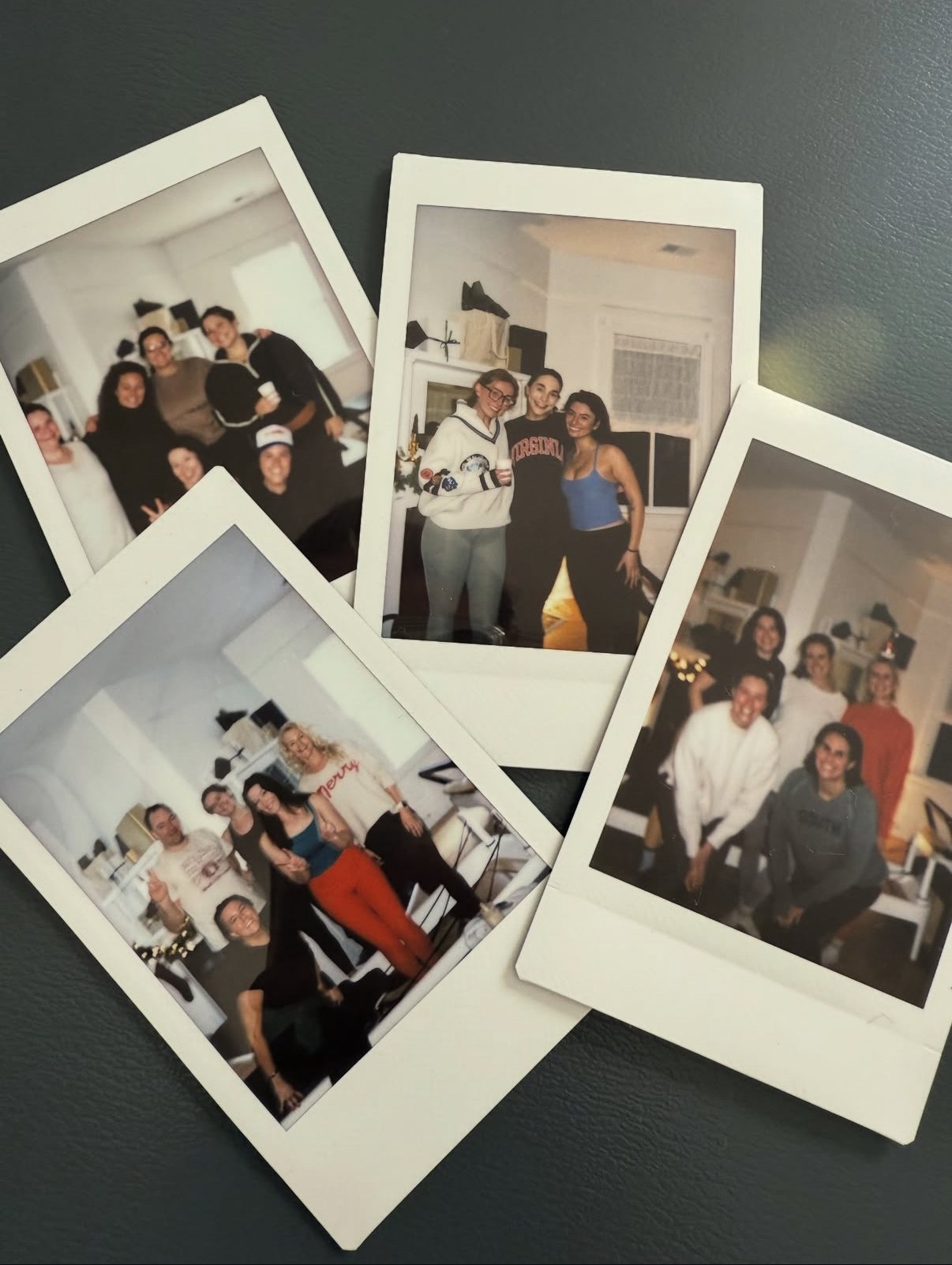 Polaroids of groups of people smiling in front of a fire place