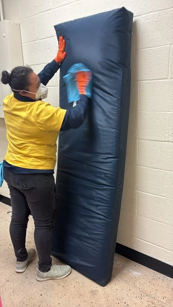 Crew member doing on-site contents cleaning of an upholstered wall pad