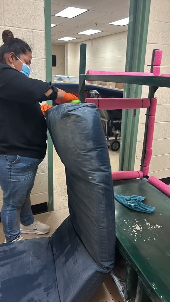 Crew member doing on-site contents cleaning of an upholstered pad