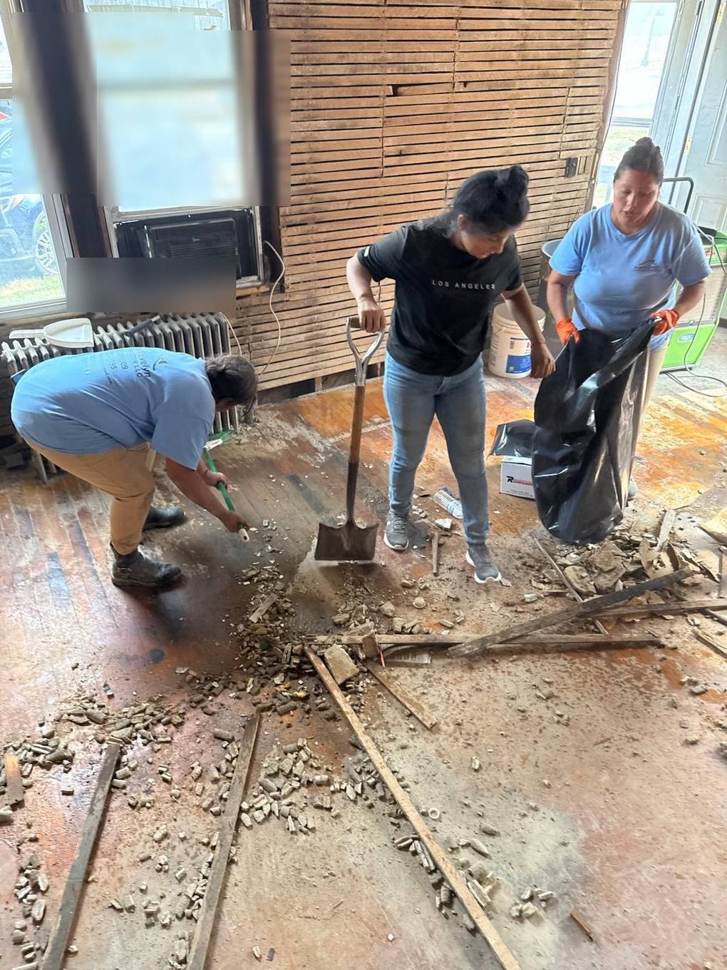 Crew members bagging debris during interior demolition cleanup