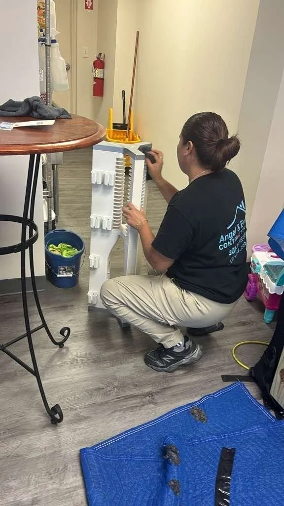 Angel & Evelyn Contractor crew member doing on-site contents cleaning of a household item