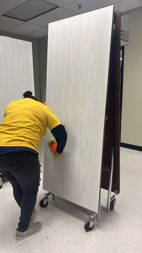 Crew member doing on-site contents cleaning of a folding table