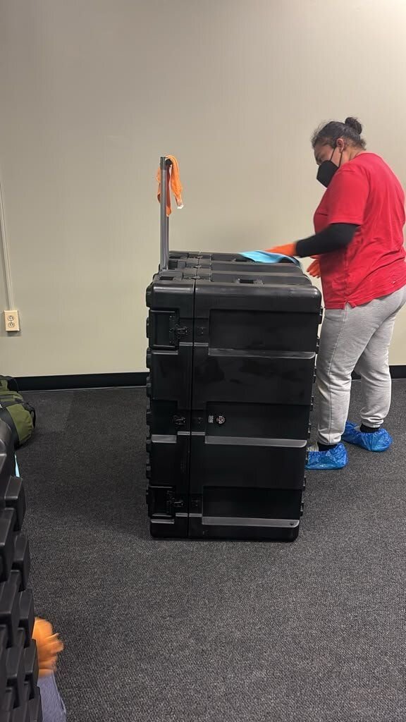 Crew member doing on-site contents cleaning of an equipment case