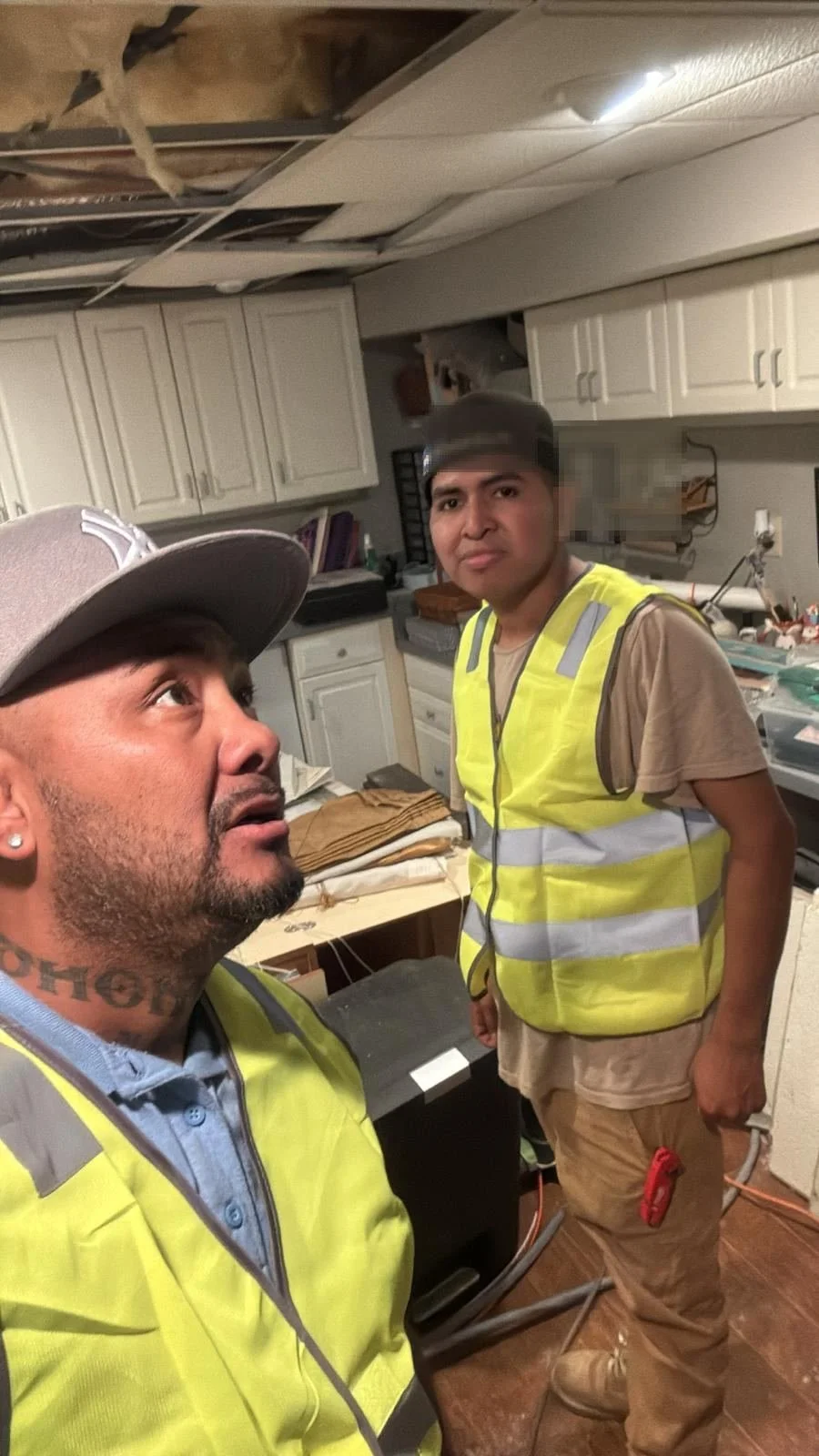 Two crew members in hi-vis vests during an interior tear-out
