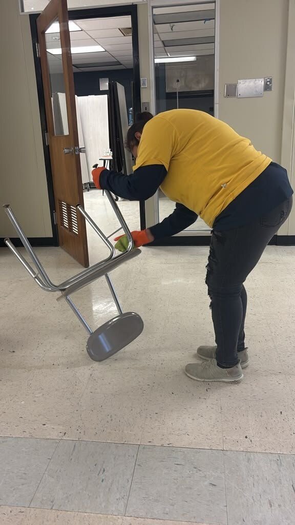 Crew member doing on-site contents cleaning of a chair