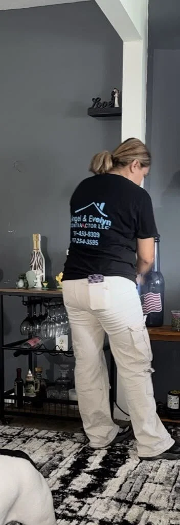Angel & Evelyn Contractor crew member doing on-site contents cleaning in a living room