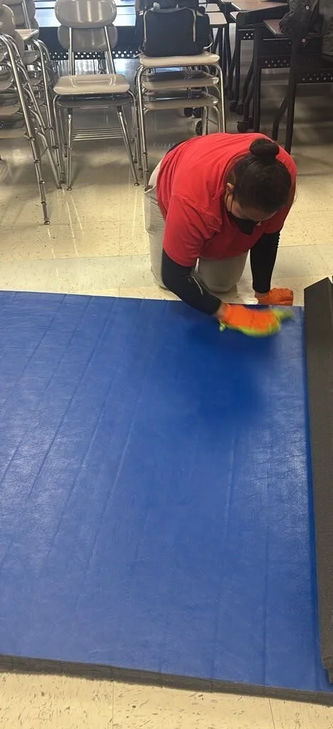Crew member doing on-site contents cleaning of an exercise mat