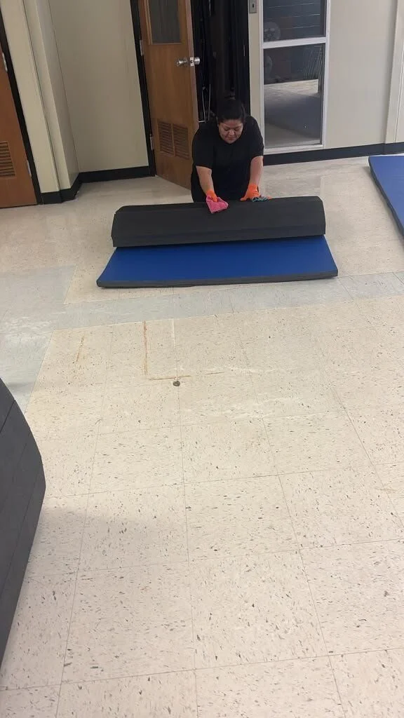 Crew member doing on-site contents cleaning of a floor mat