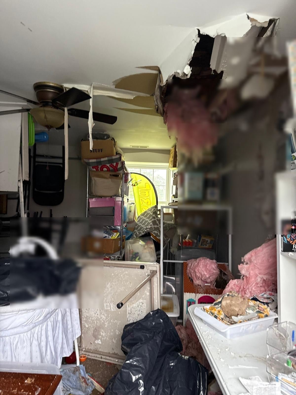Water-damaged ceiling with collapsed drywall and insulation before restoration