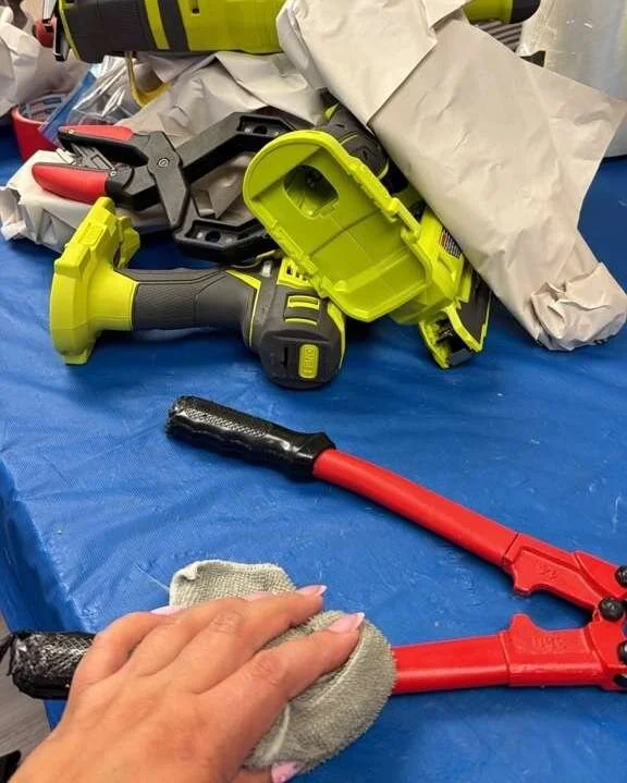 Crew member's hand doing on-site contents cleaning of tools