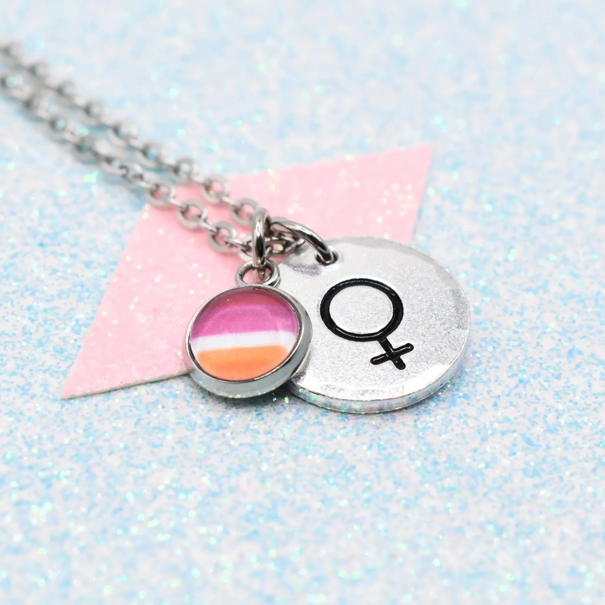 A custom pride flag necklace in silver for a lesbian identifying person