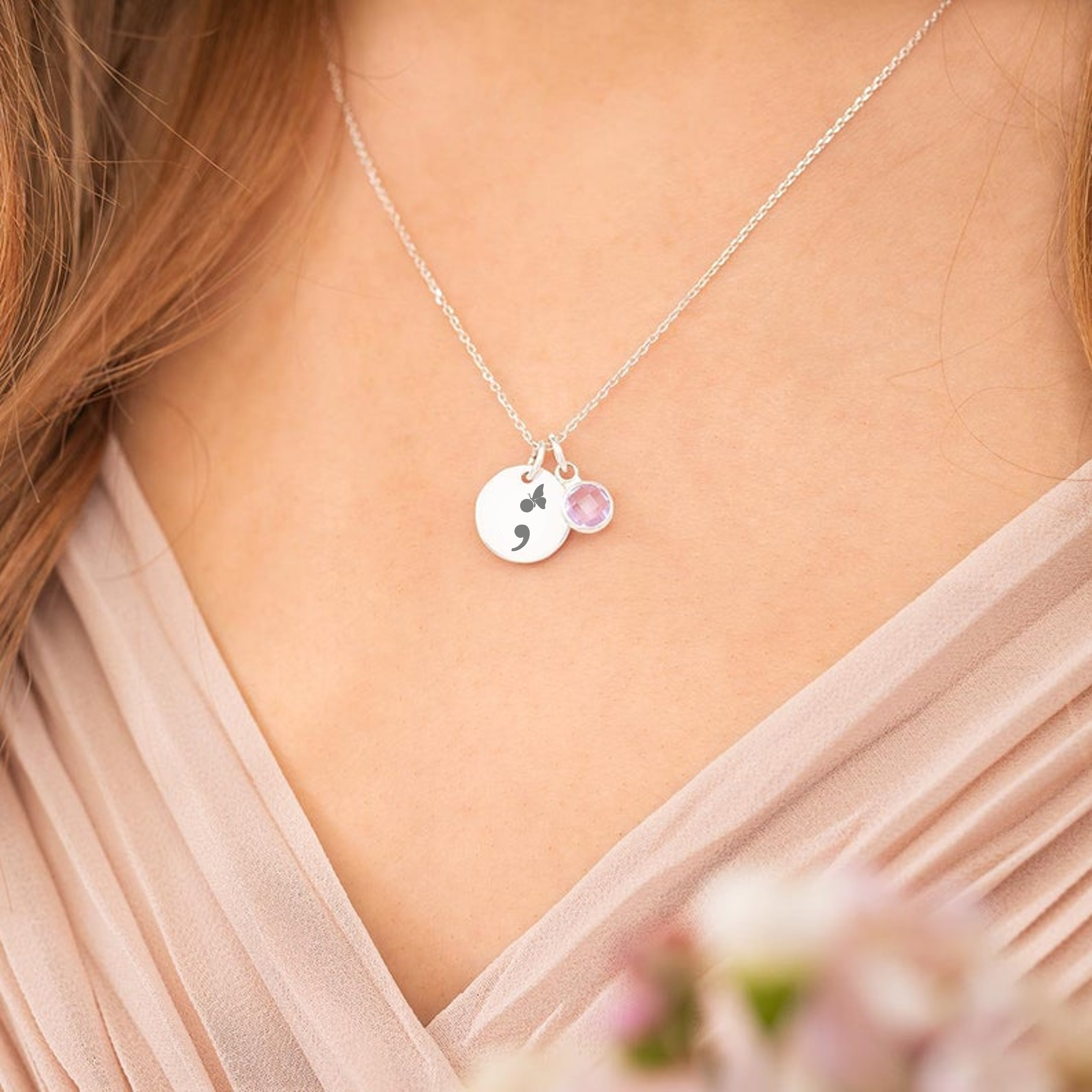 A model wearing a semi colon necklace featuring a butterfly for Mental Health Awareness