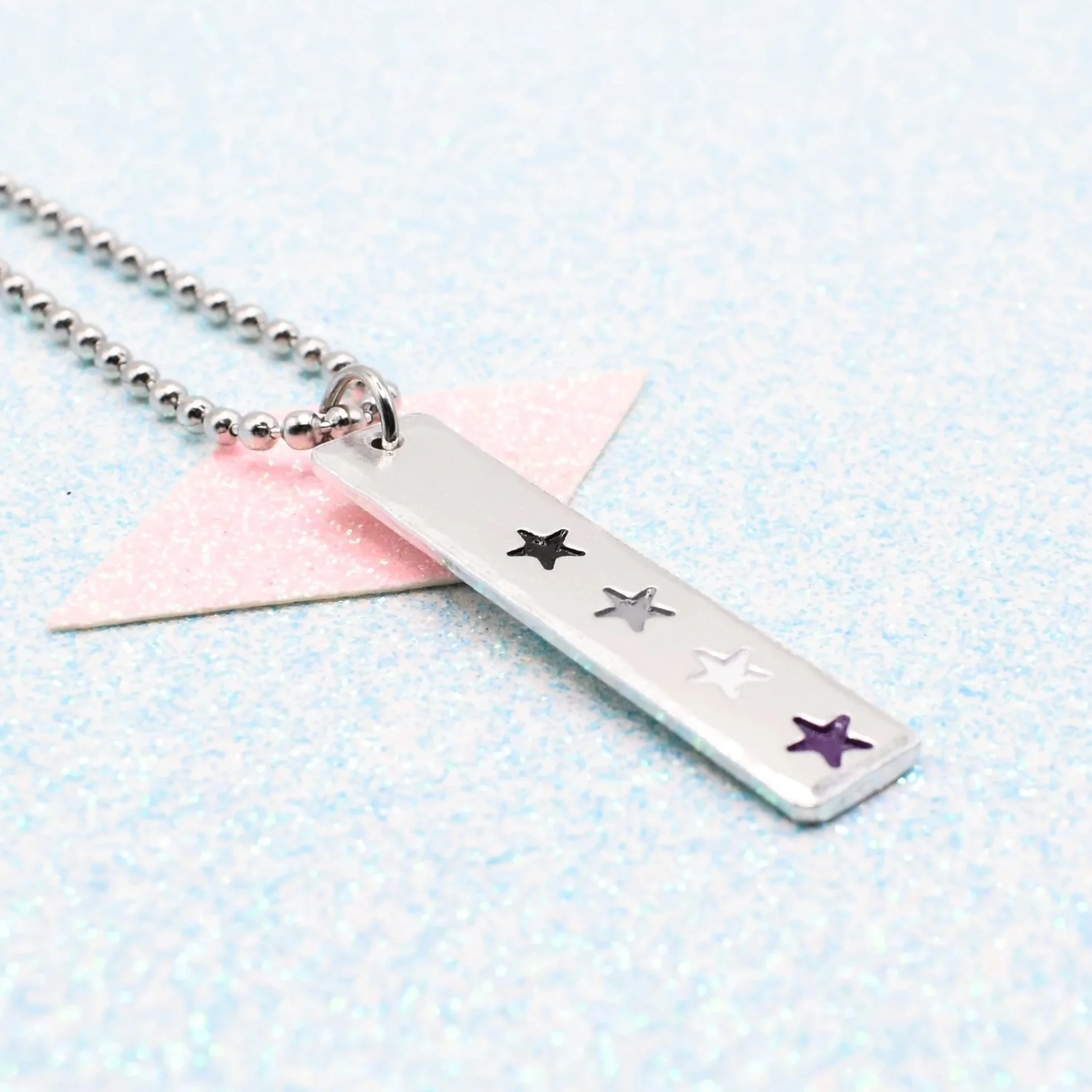 Vertical bar necklace featuring asexual flag enamel stars black grey white purple