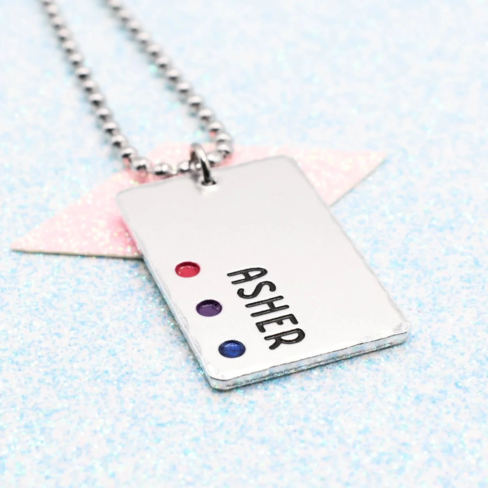 Bisexual pride necklace with enamelled pink, purple, and blue accents