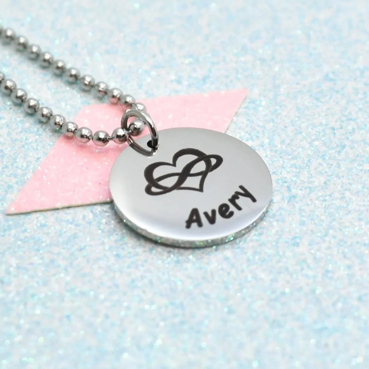 Personalised polyamory pride jewellery featuring engraved pride symbol
