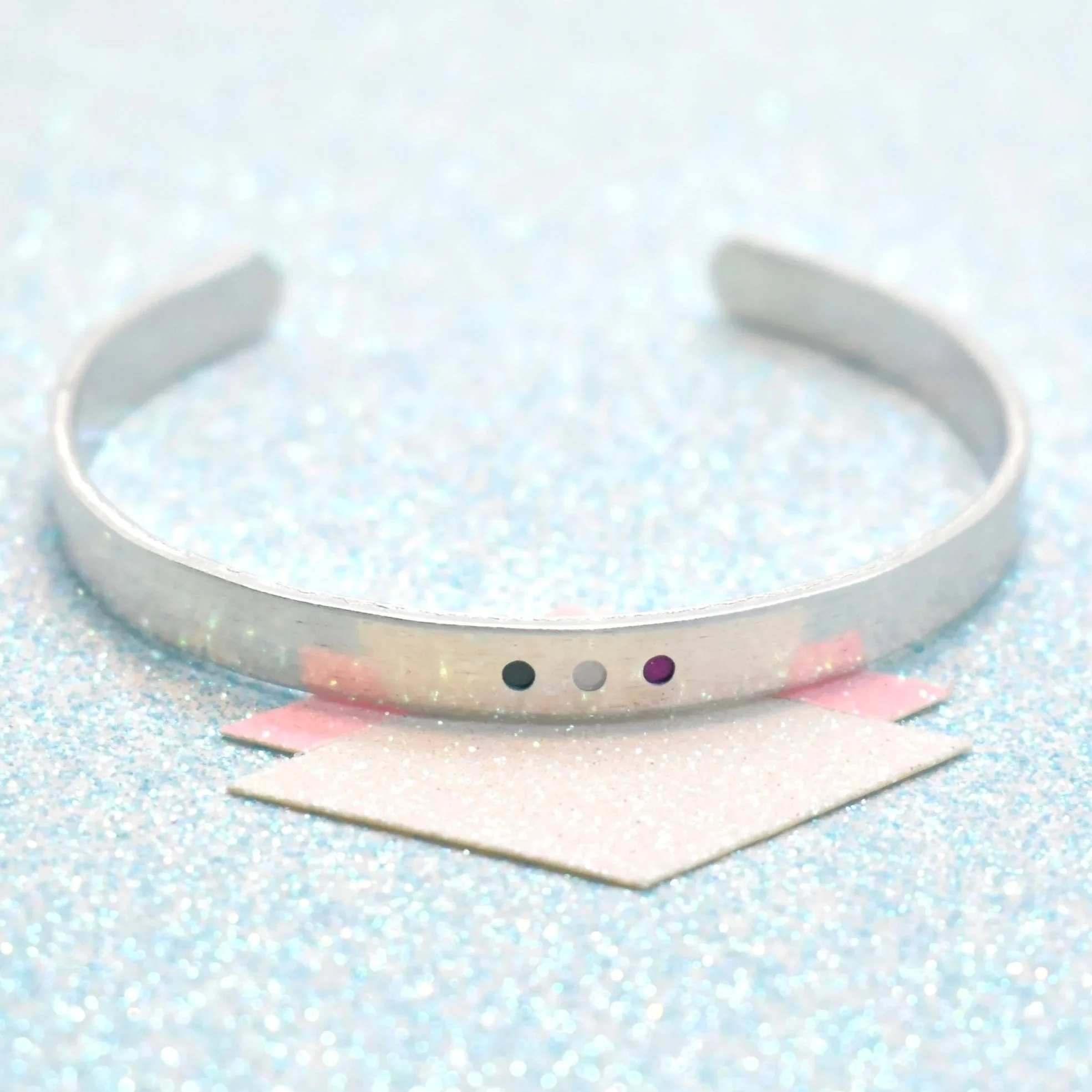 Adjustable cuff bracelet featuring genderqueer flag colours lavender white green