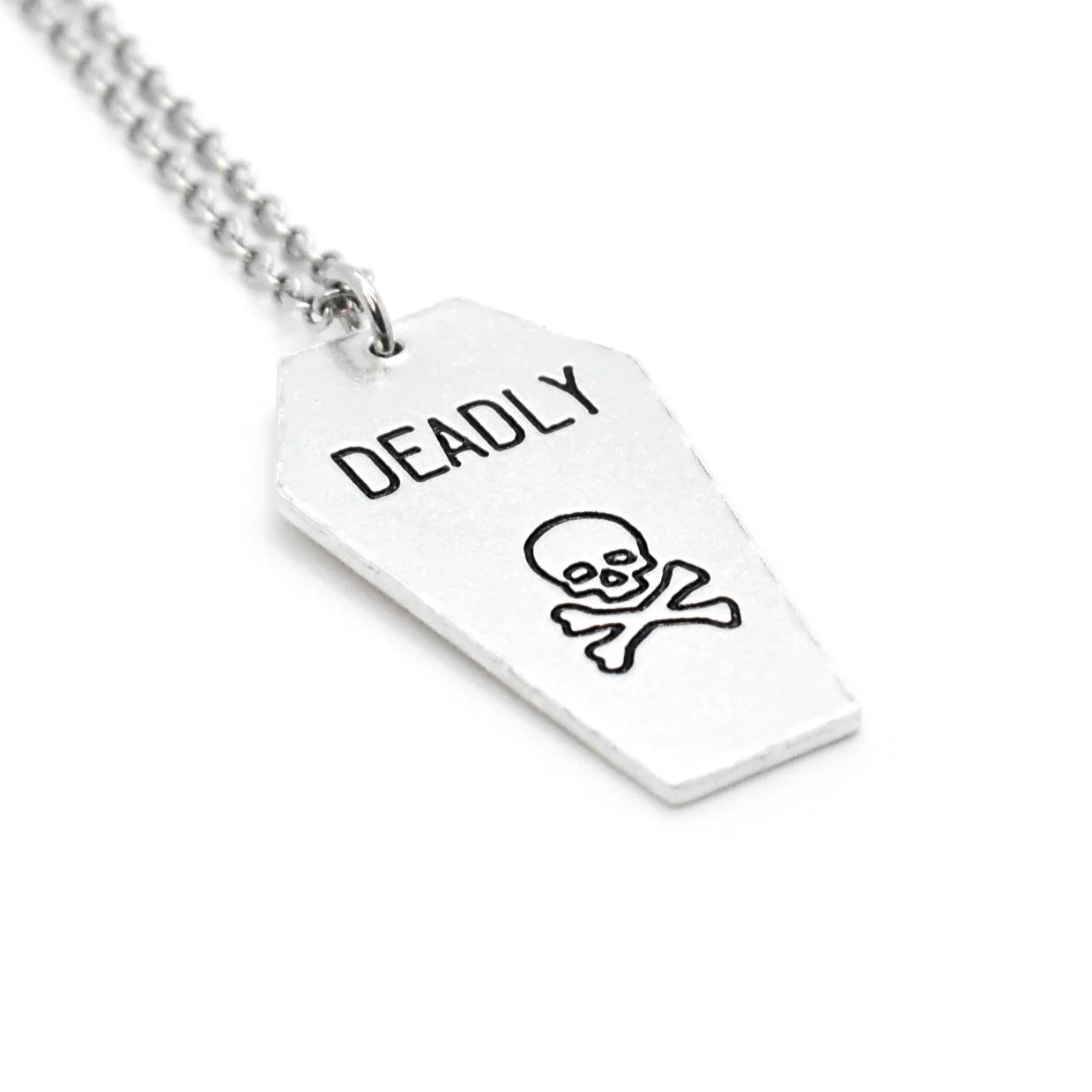 coffin pendant engraved with deadly skull and bones design