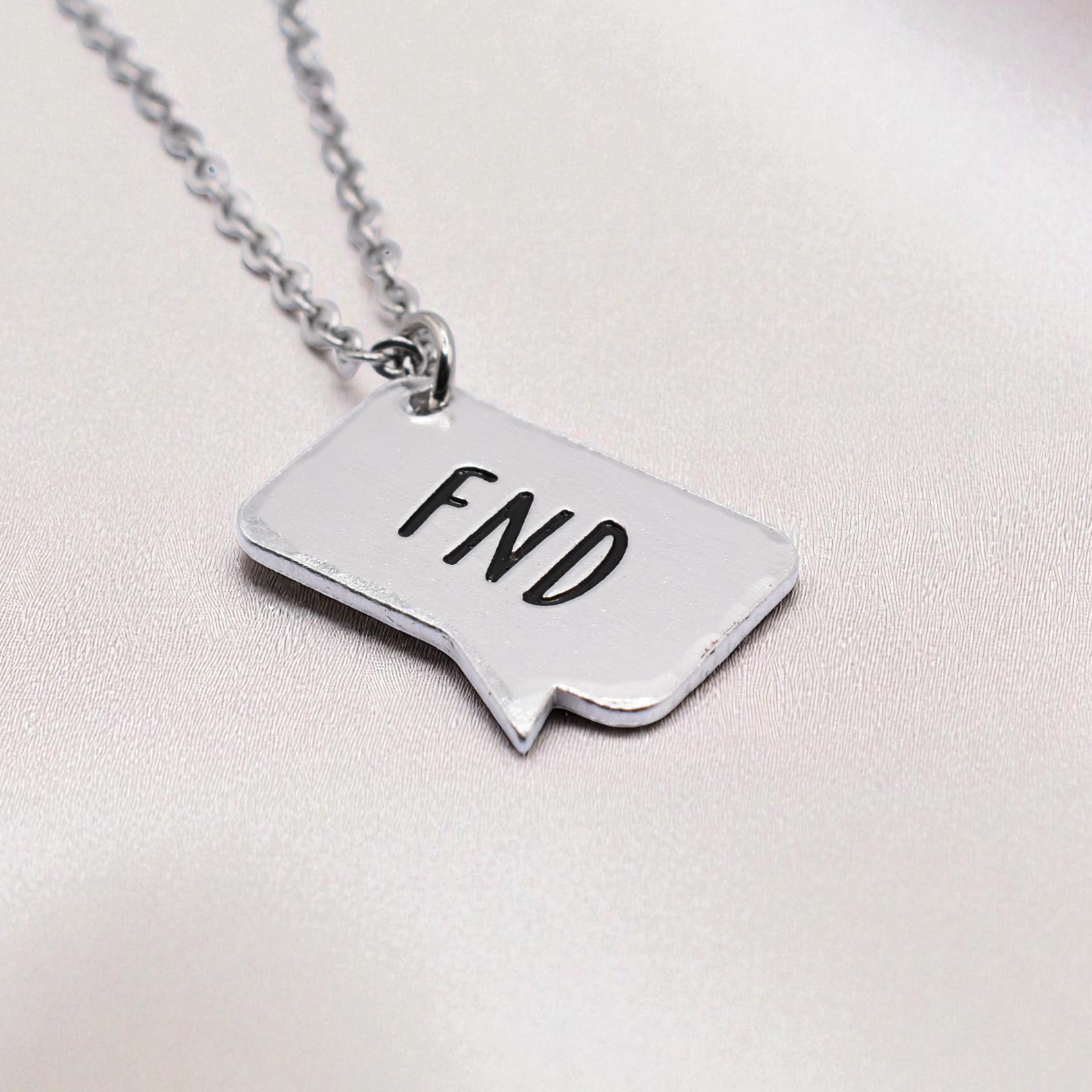 Custom Coven FND awareness jewellery – enamel-stamped charm for strength and advocacy