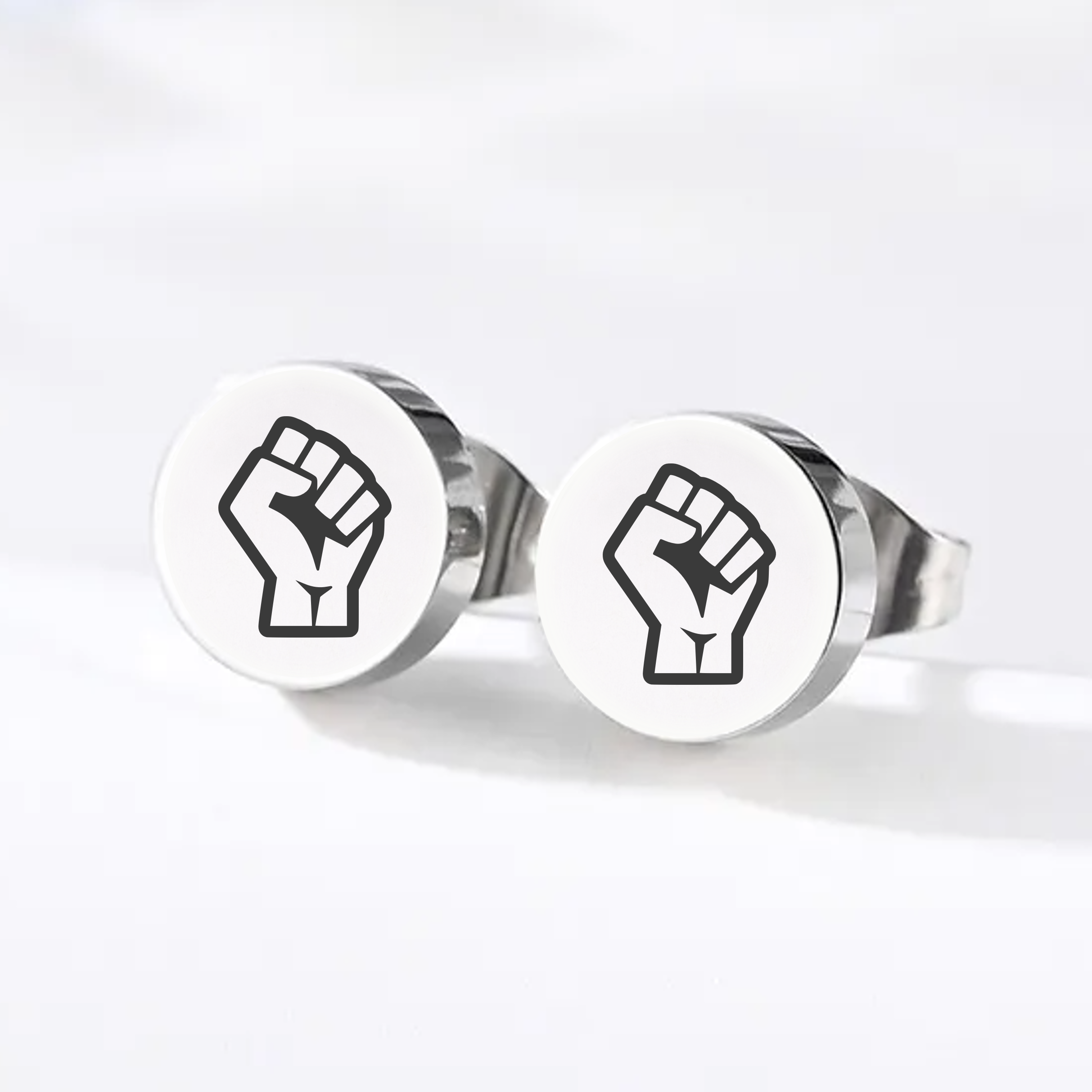 Engraved Resist pride stud earrings with raised fist design