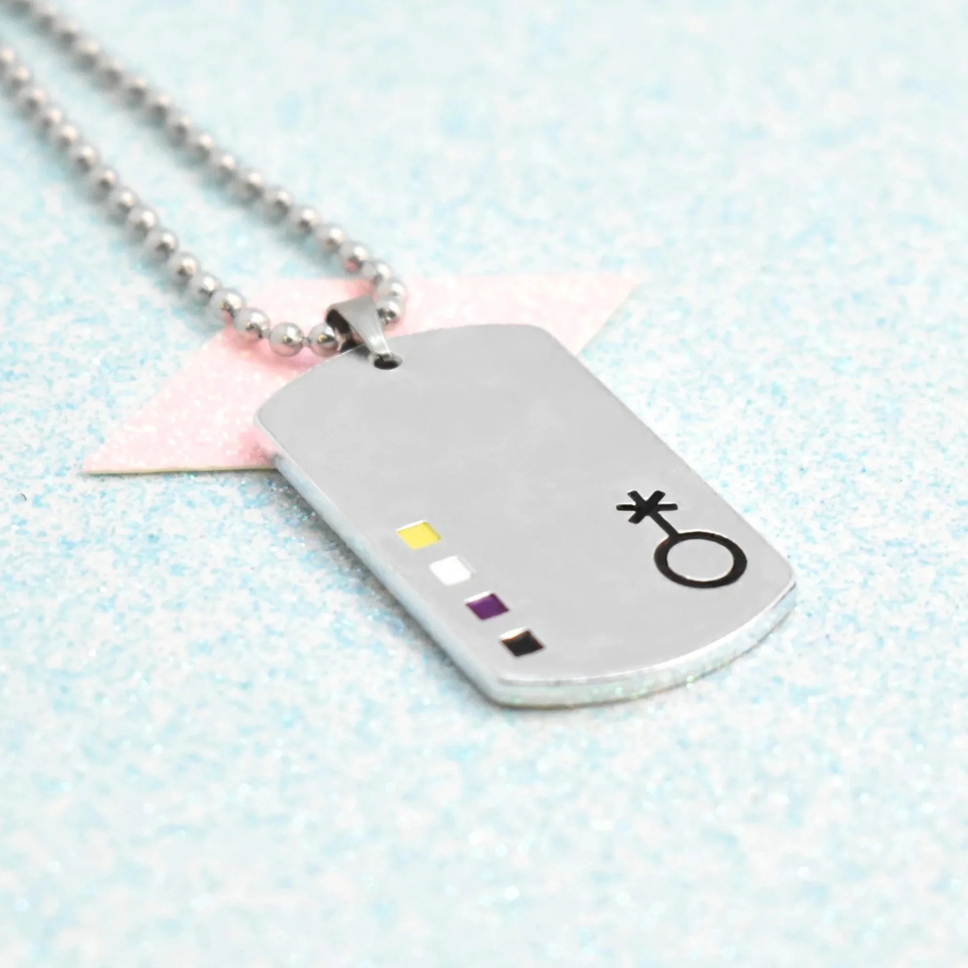 Pendant with non-binary pride symbol and yellow, white, purple, black enamel colours