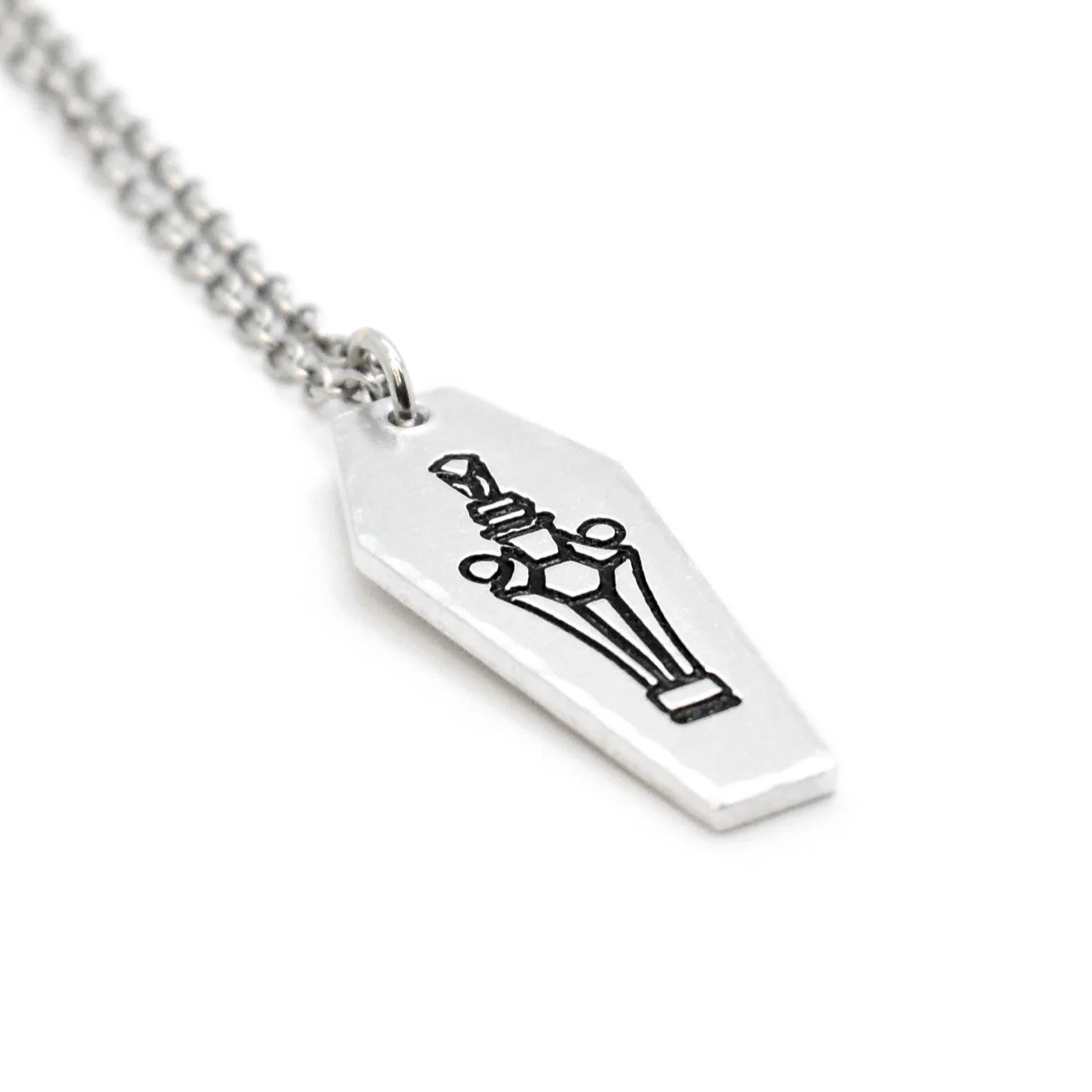 coffin pendant engraved with potion bottle occult charm