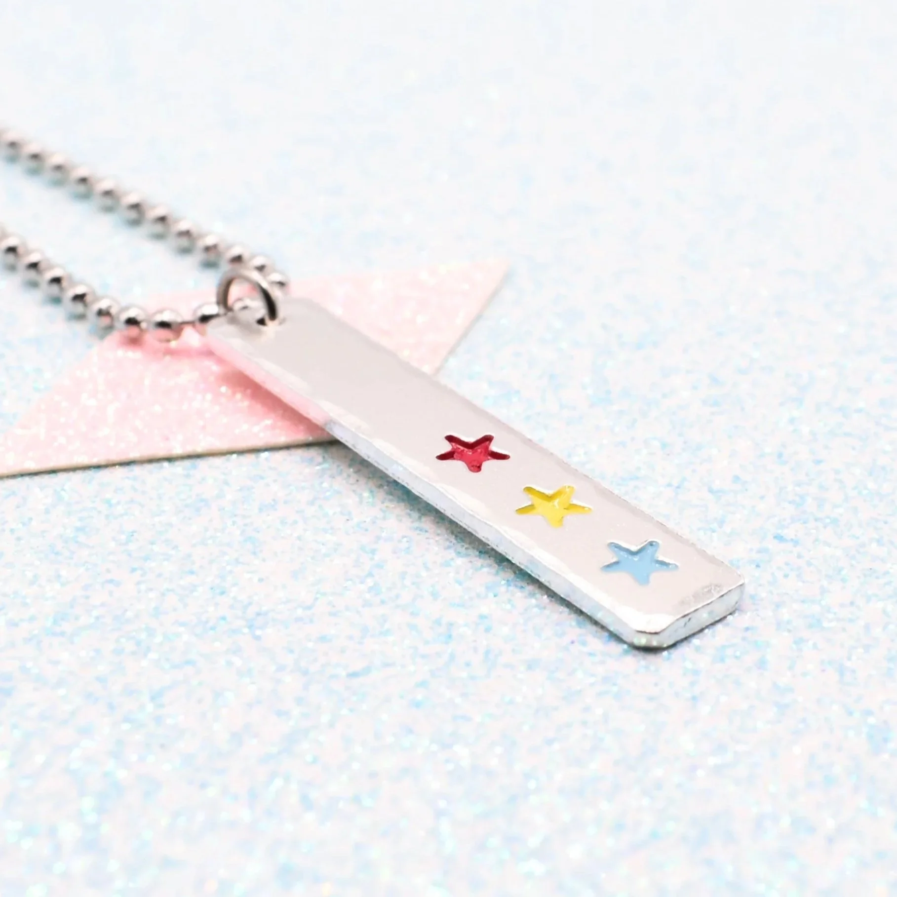 Vertical bar necklace featuring pansexual flag enamel stars pink yellow blue