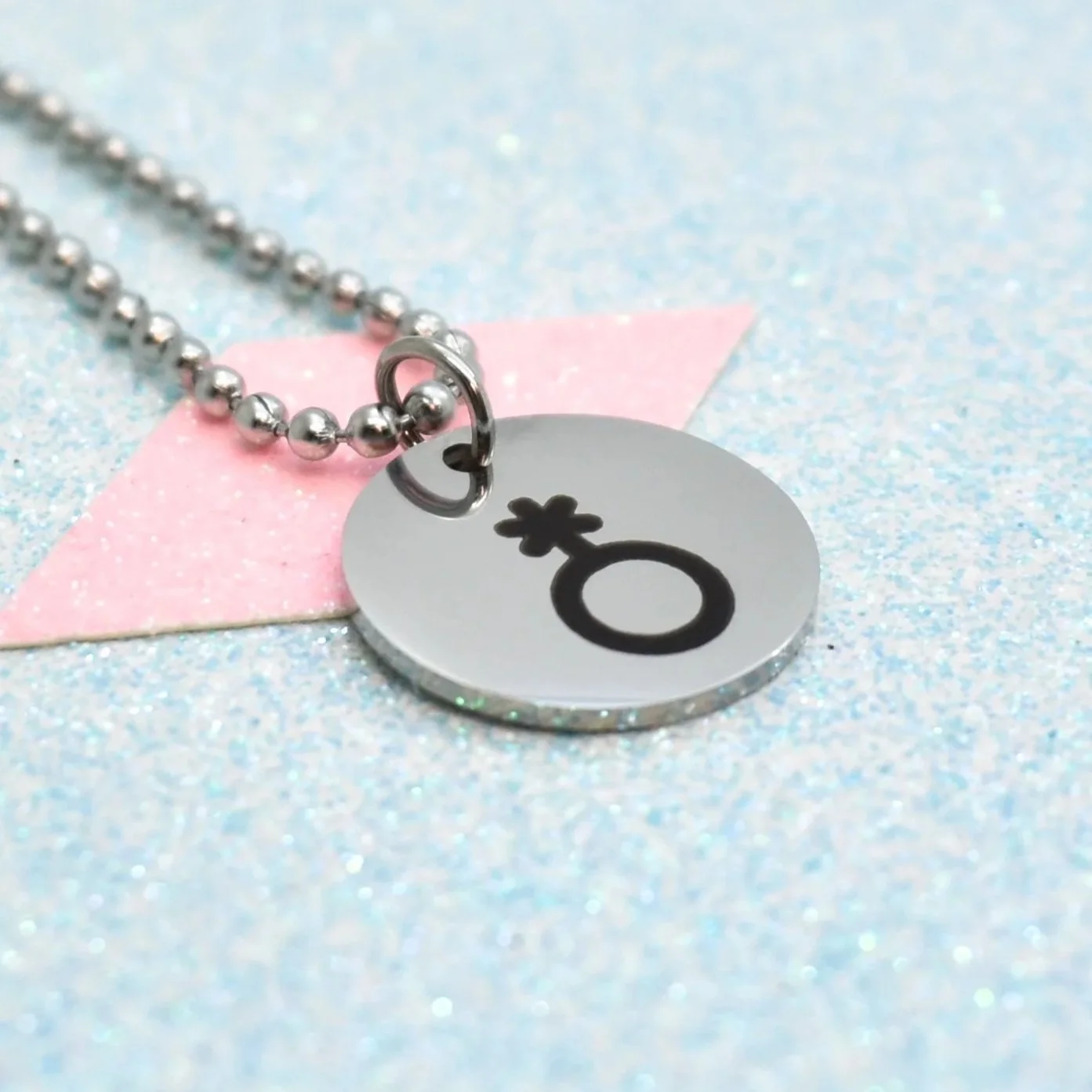 Non-binary necklace with engraved non-binary pride symbol on silver chain