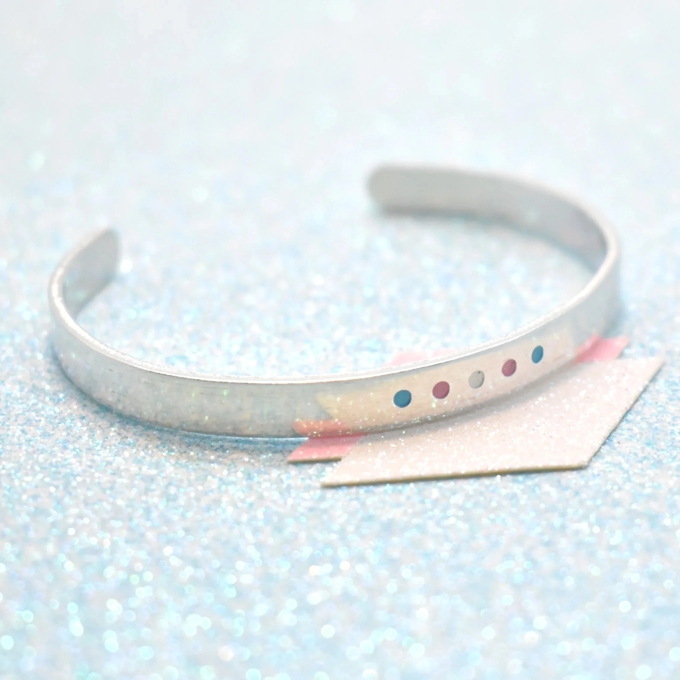 Adjustable cuff bracelet featuring transgender flag colours pink blue white