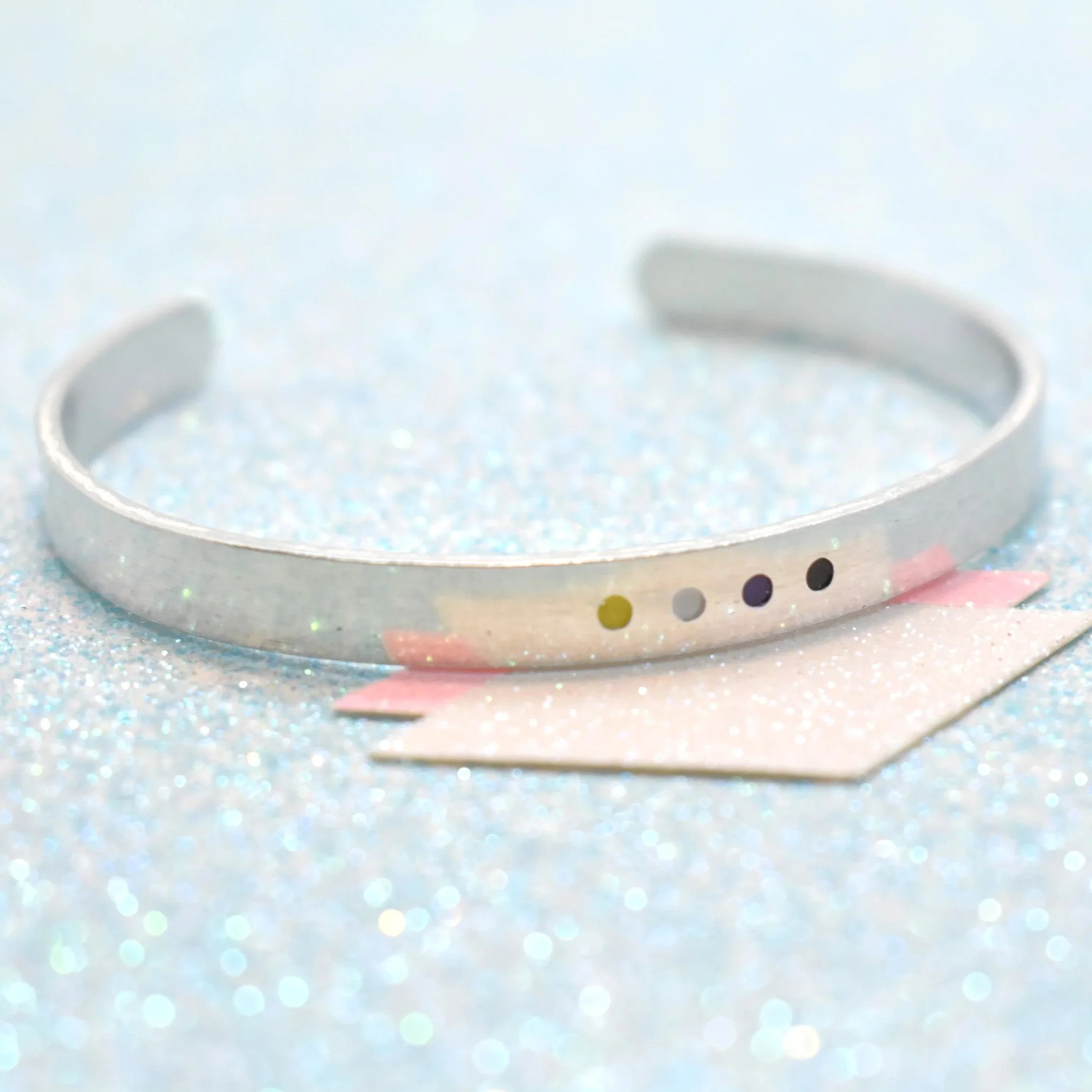 Handmade non-binary pride cuff bracelet with enamel dot design