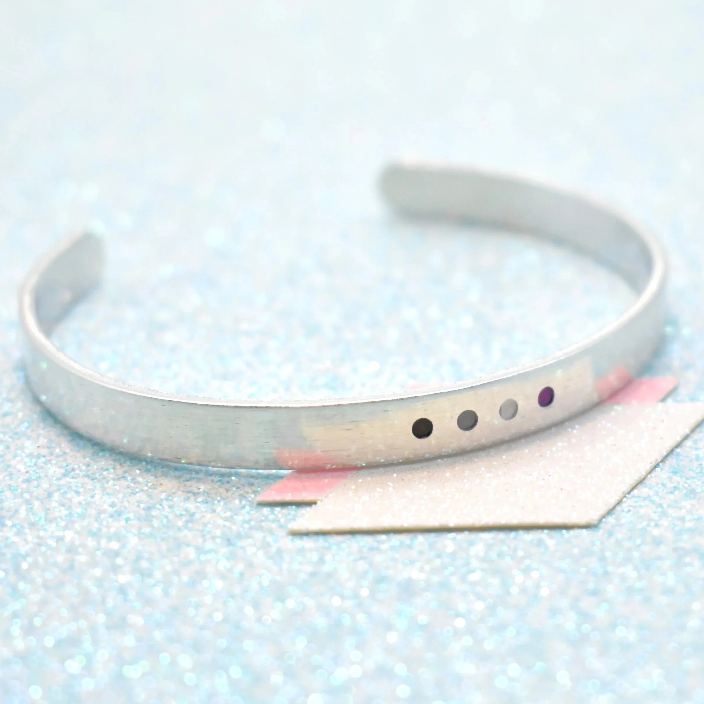 Adjustable cuff bracelet featuring asexual flag colours black grey white purple