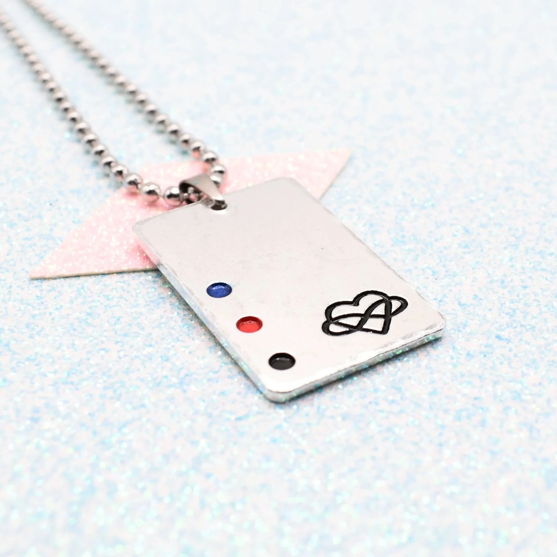 Hand-stamped polyamorous necklace enamelled with red, blue and black