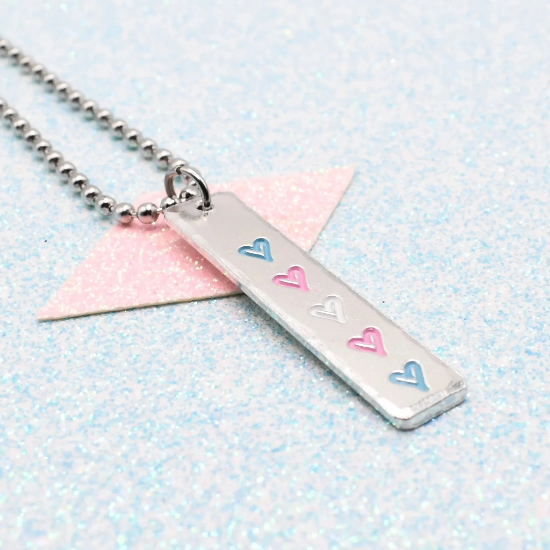 Hand stamped enamelled transgender pride necklace with heart pendant