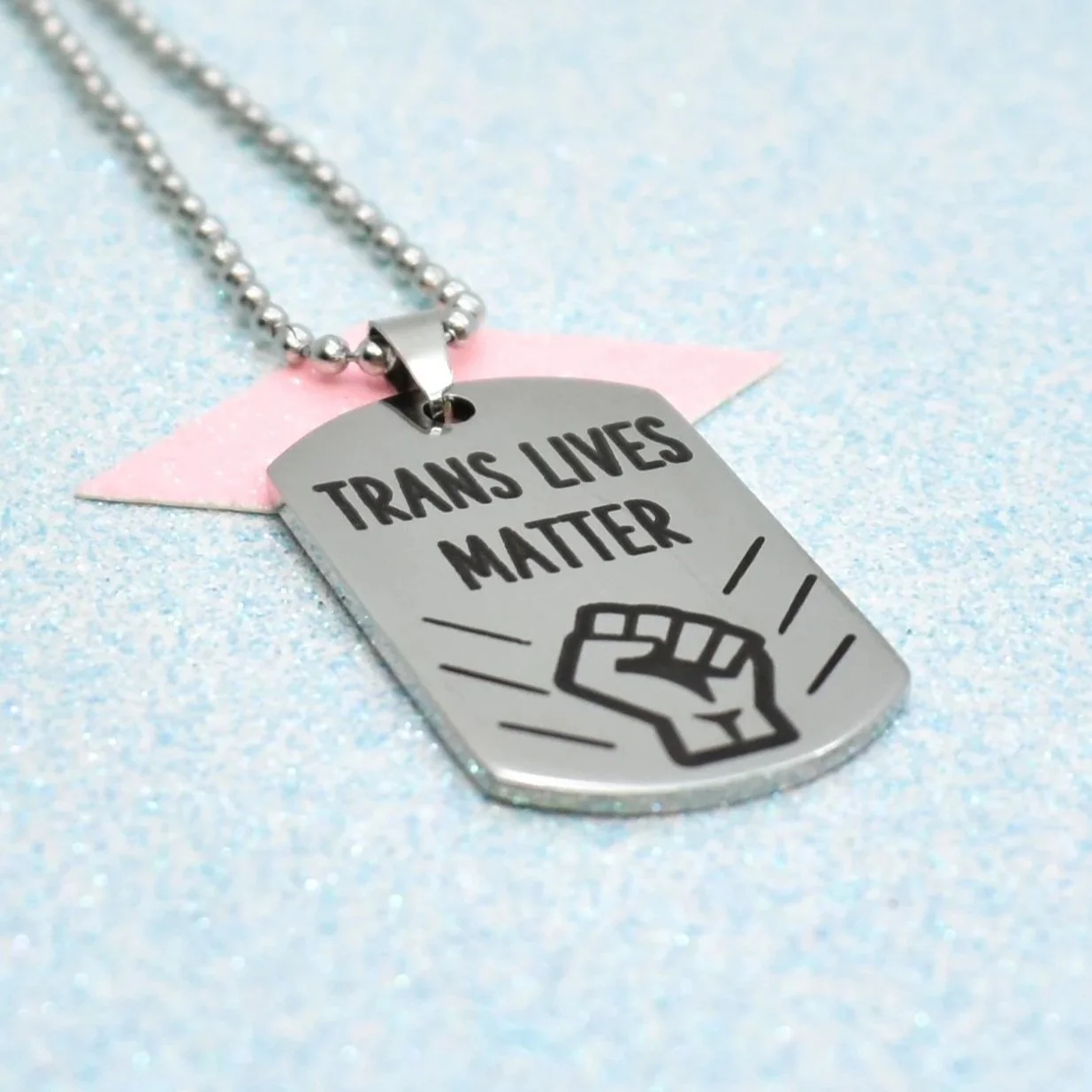 Silver Trans Lives Matter protest necklace with engraved fist design