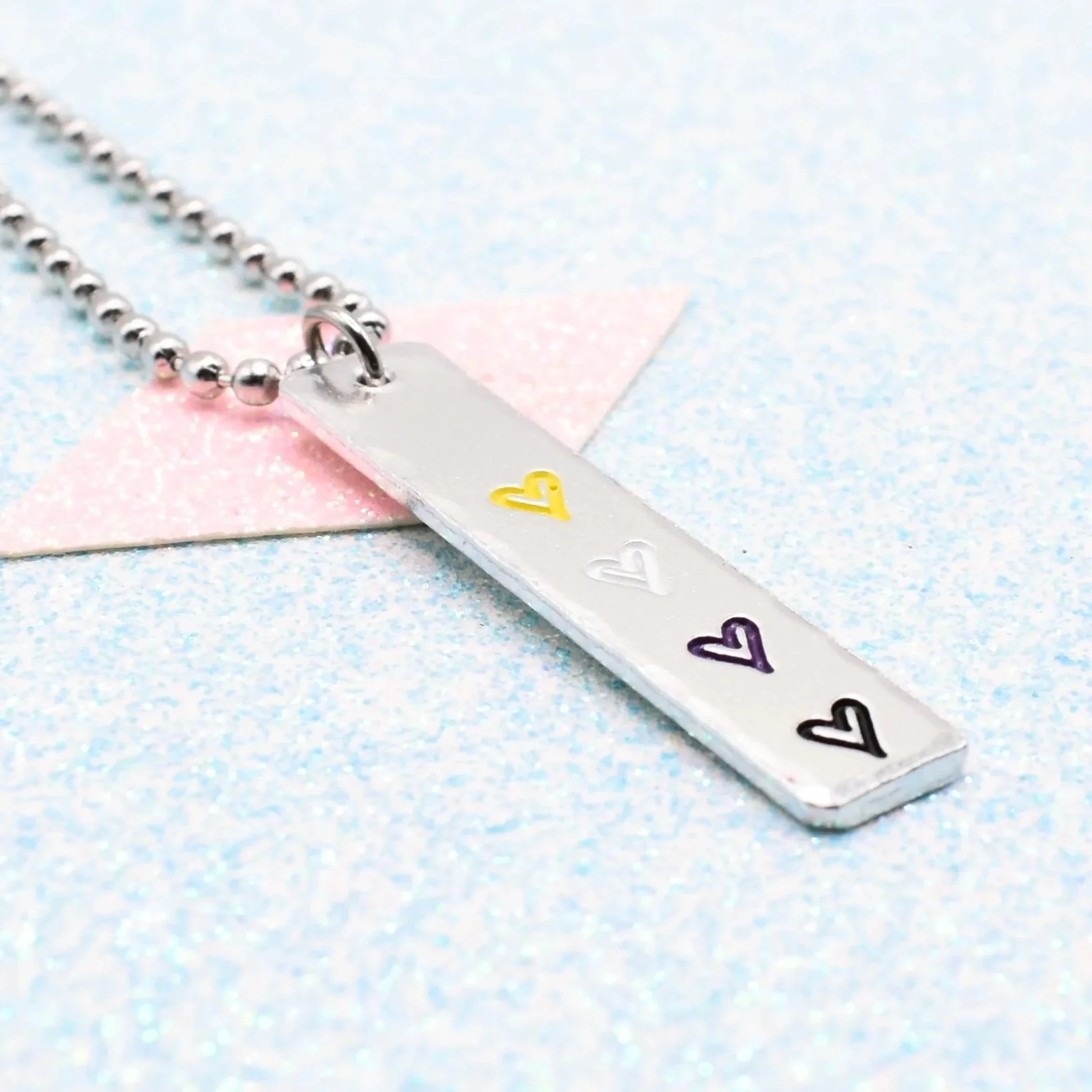 Hand stamped enamelled non-binary pride necklace with heart pendant