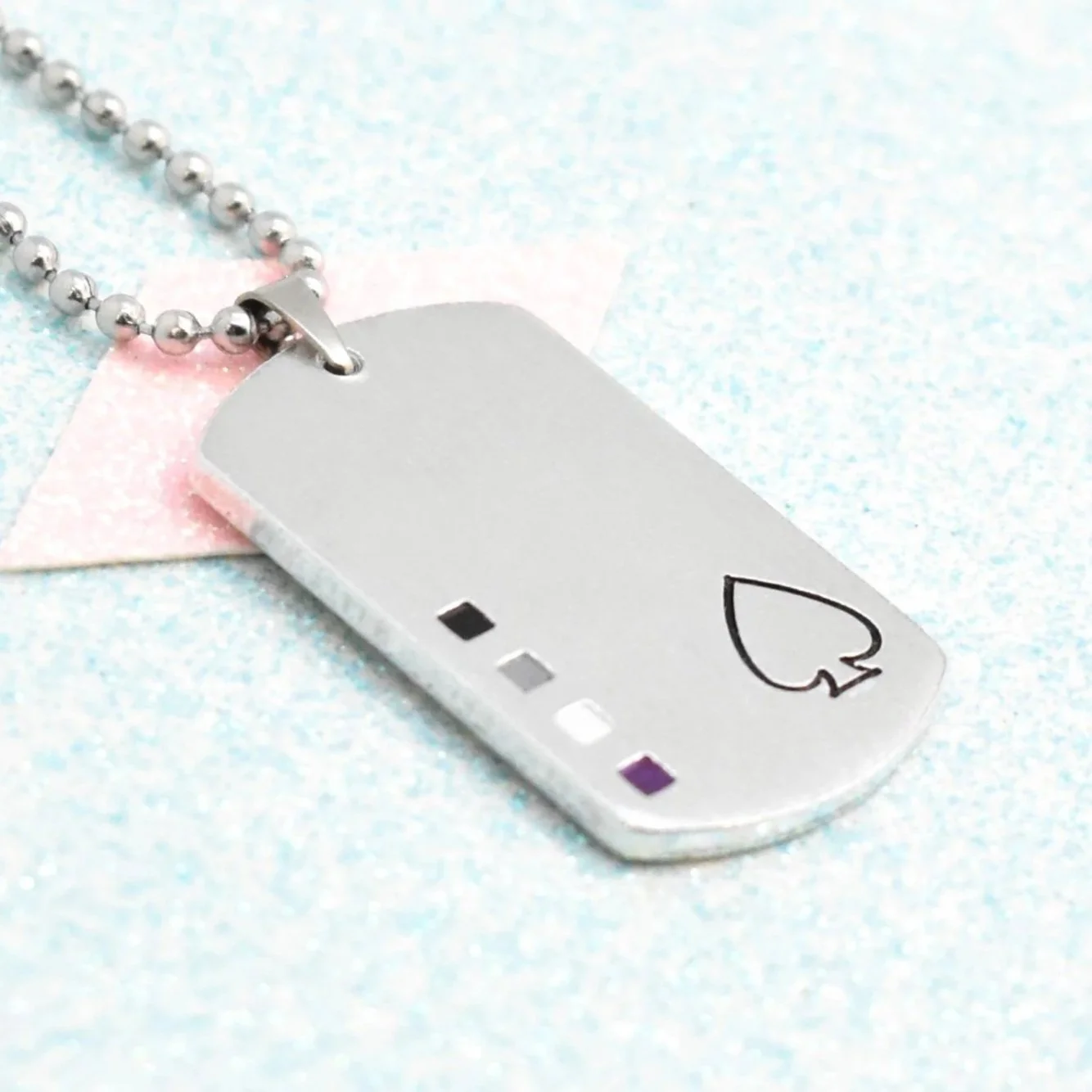 Pendant hand-stamped with ace spade symbol and asexual flag colours