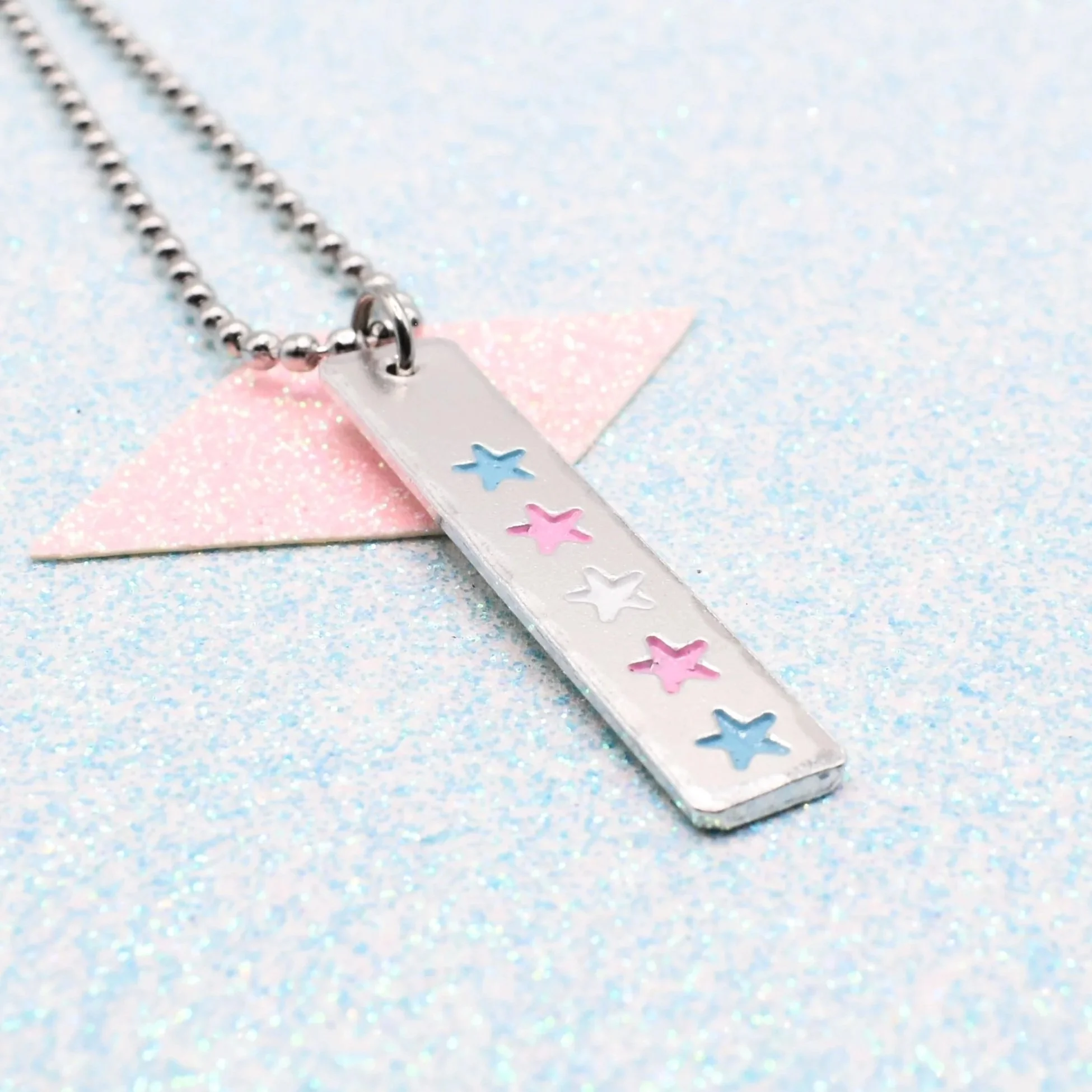 Hand stamped enamelled transgender pride necklace with star design