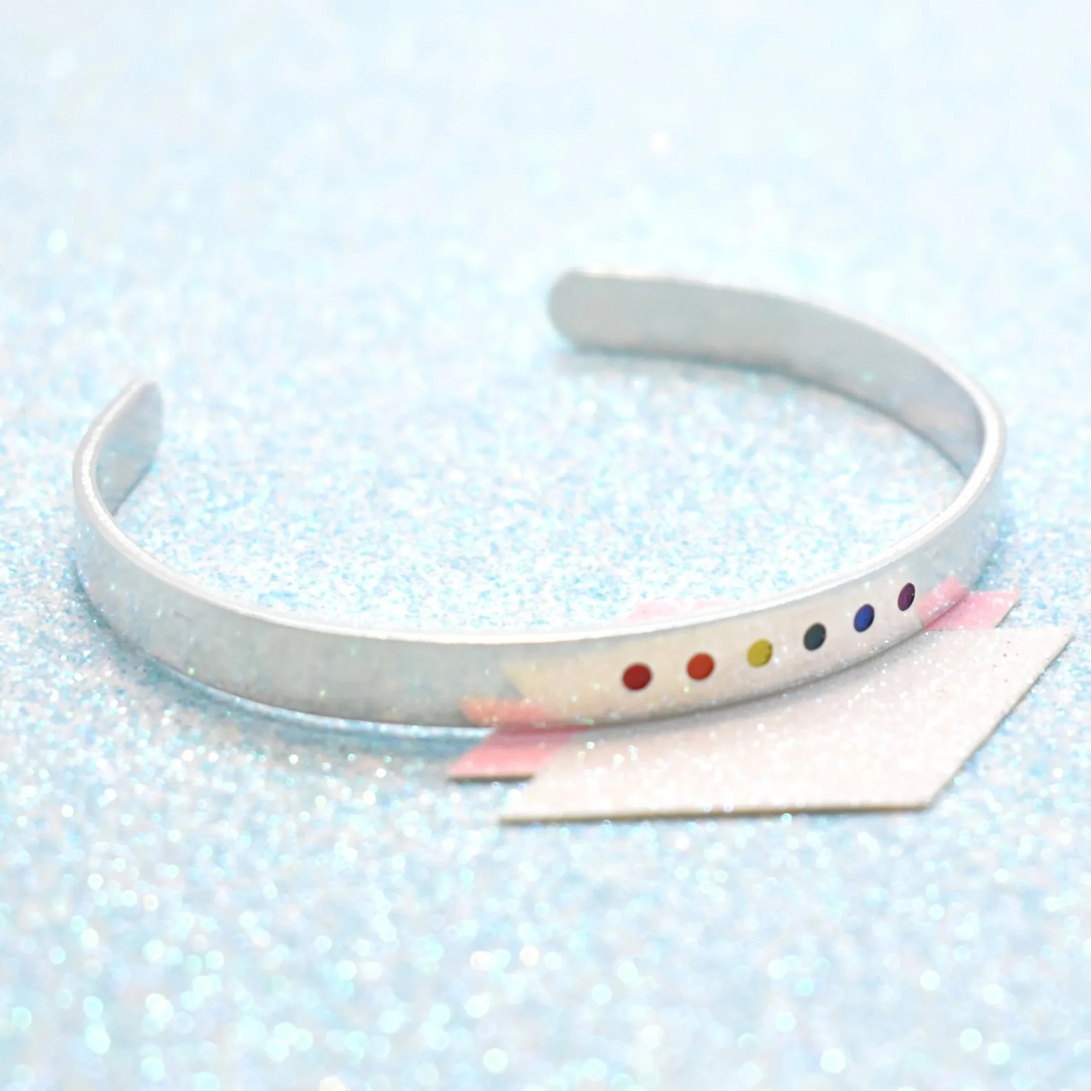 Handmade rainbow flag bracelet paired with pride necklaces