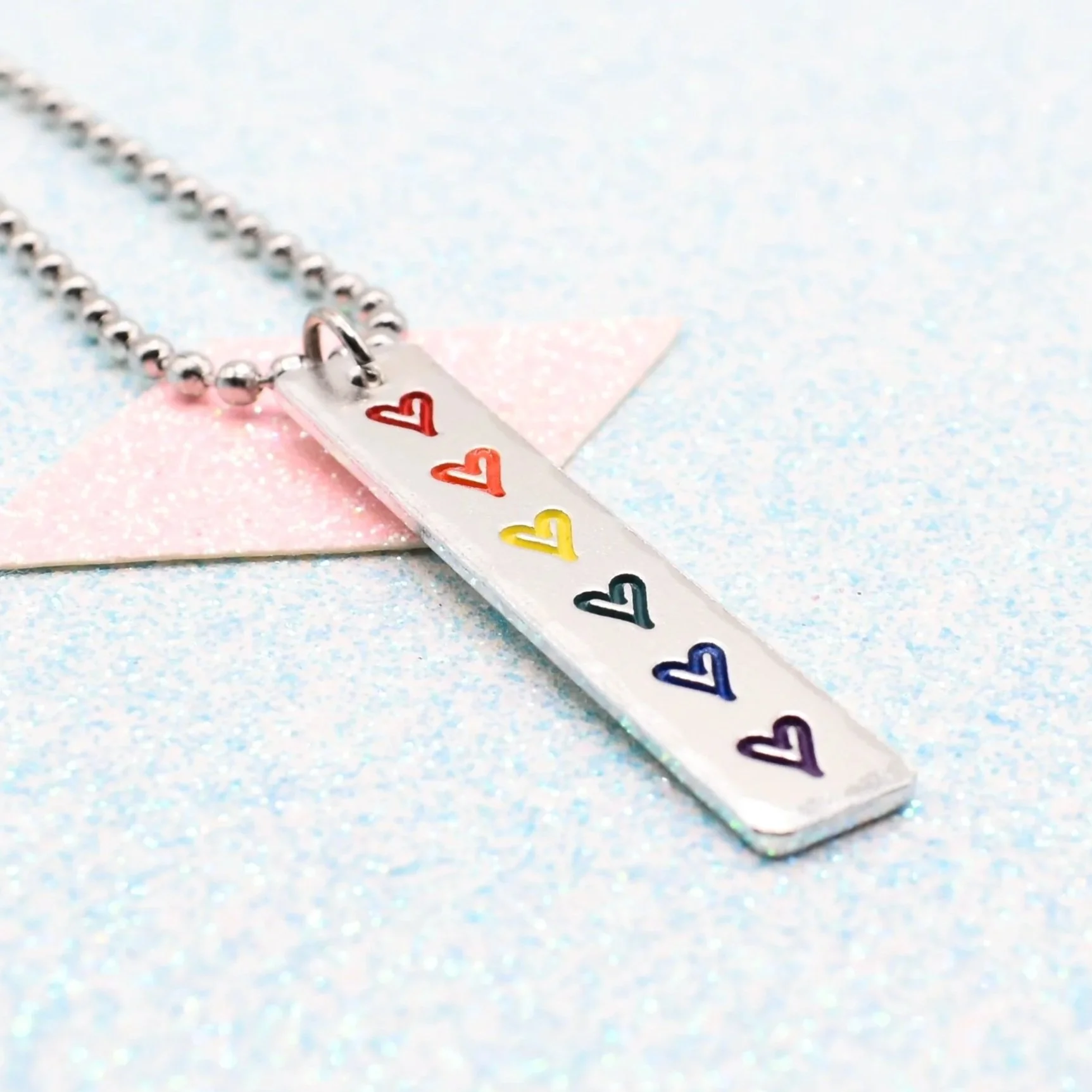Hand stamped enamelled rainbow pride necklace with heart pendant