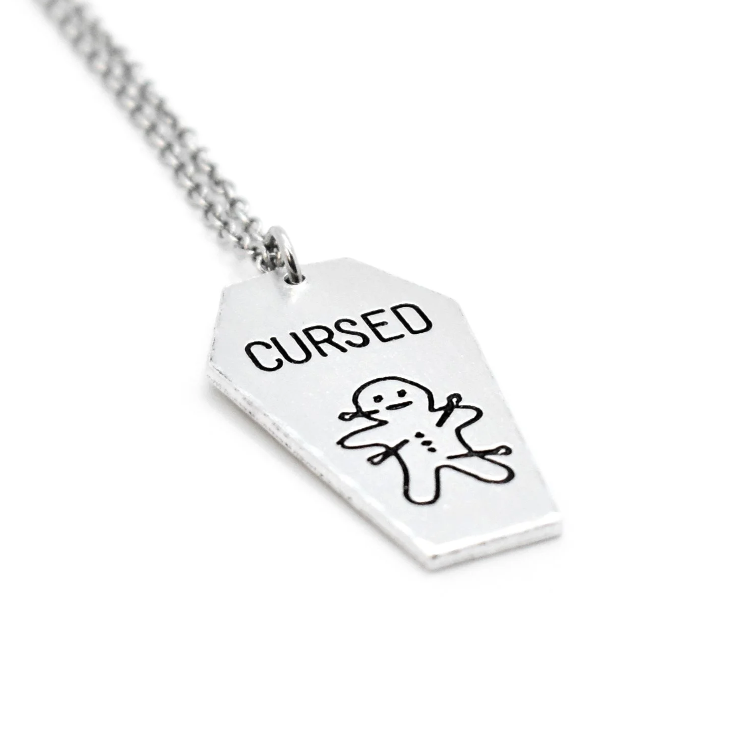 coffin pendant engraved with cursed voodoo doll design