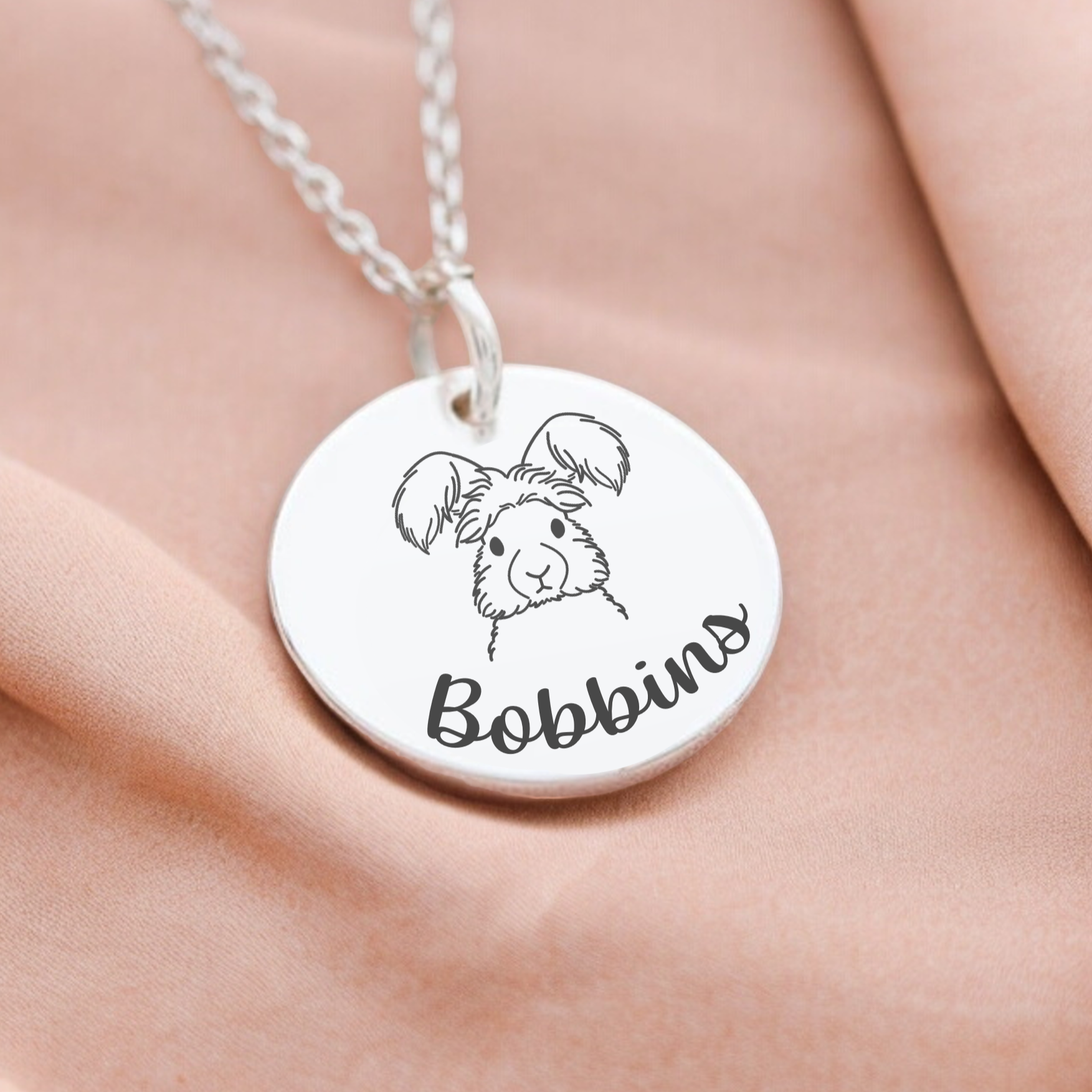 A memorial rabbit necklace featuring a personalised name
