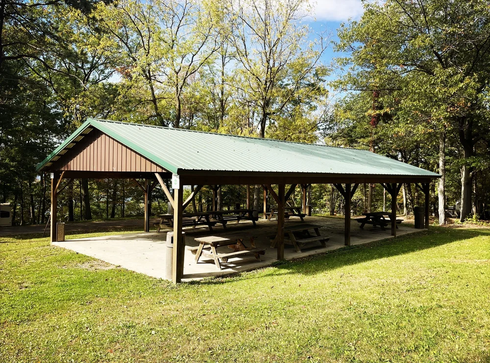 A covered picnic pavilion with wooden tables at Smith Memorial Park