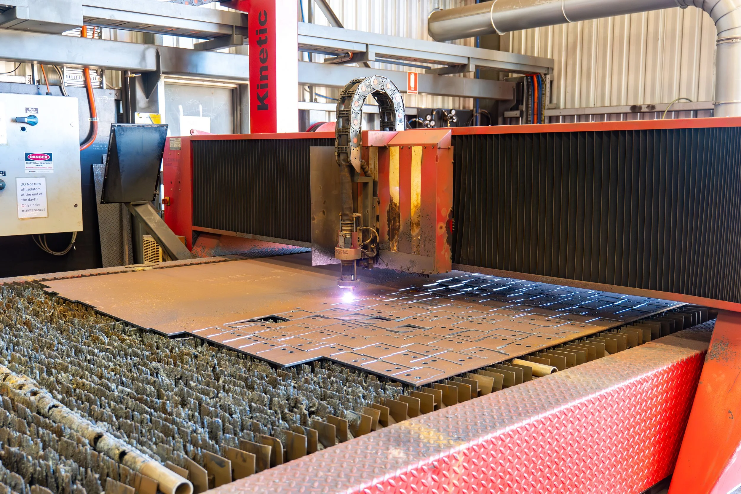 Industrial laser cutting machine cutting metal sheet in a factory