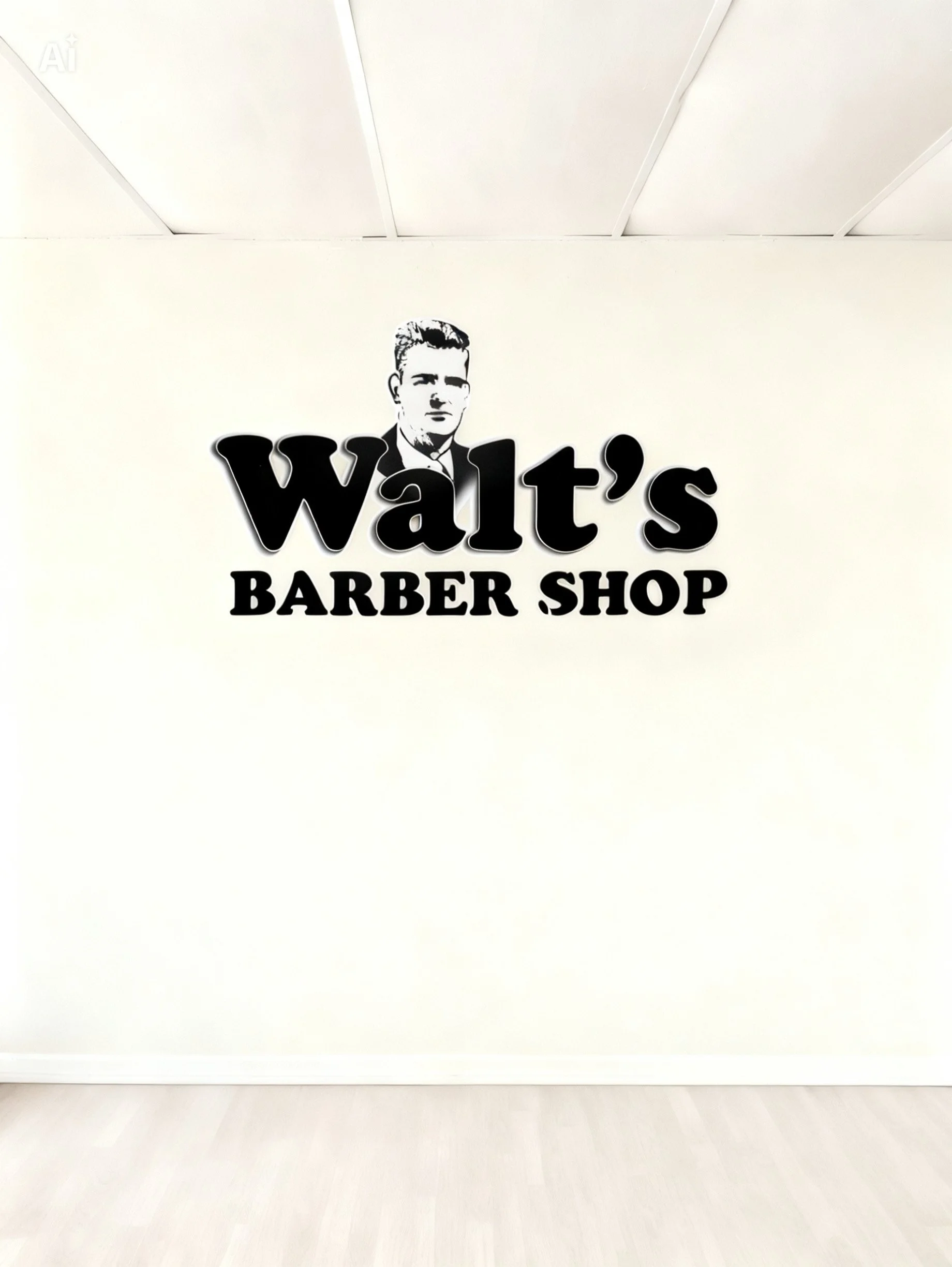 Wall sign with a black and white line drawing of a man with short hair and a suit, and the text 'Walt's BARBER SHOP' in bold black letters.